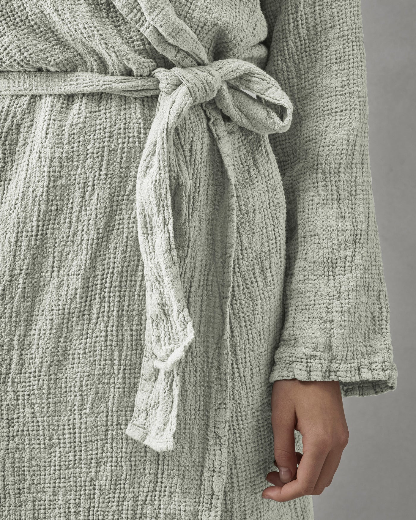 Close-up of Society Limonta Lipe New robe belt tied at waist in sage textured cotton gauze.