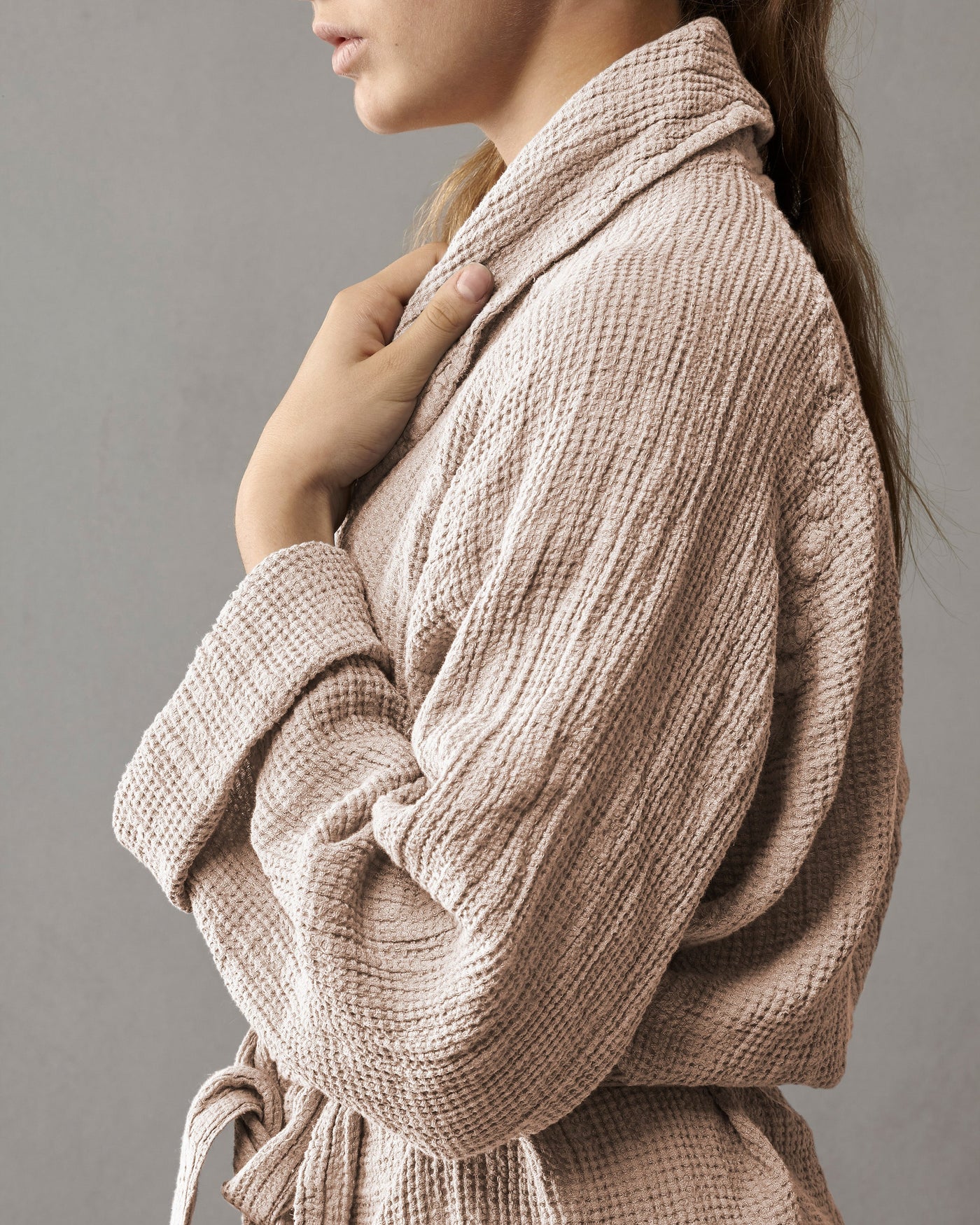 Close-up of waffle-textured blush robe showing shawl collar and belted waist detail.
