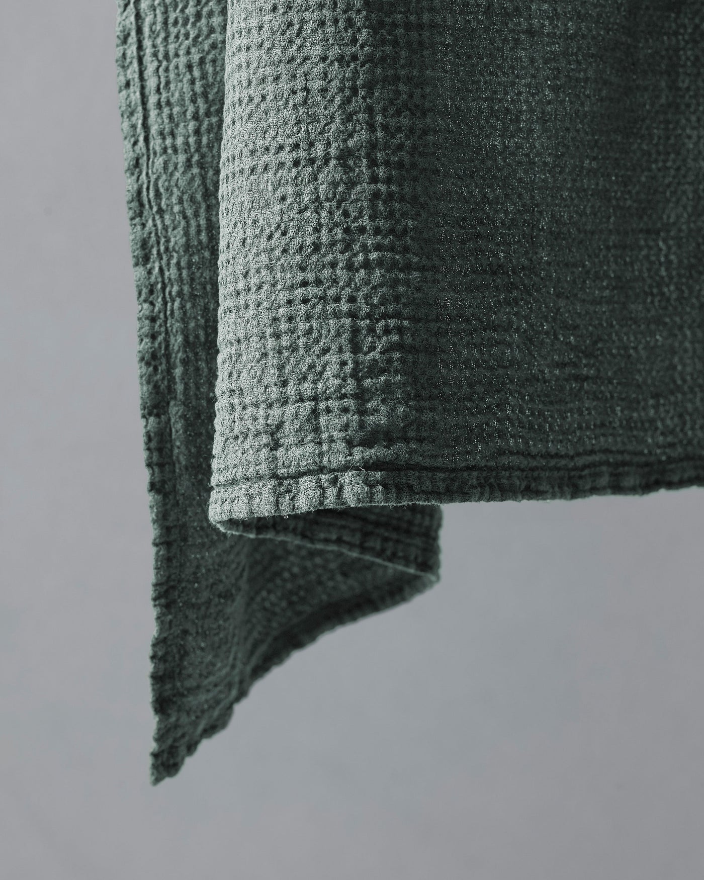 Close-up of Society Limonta Lipe New hand towel corner in sage, showing waffle-weave texture.