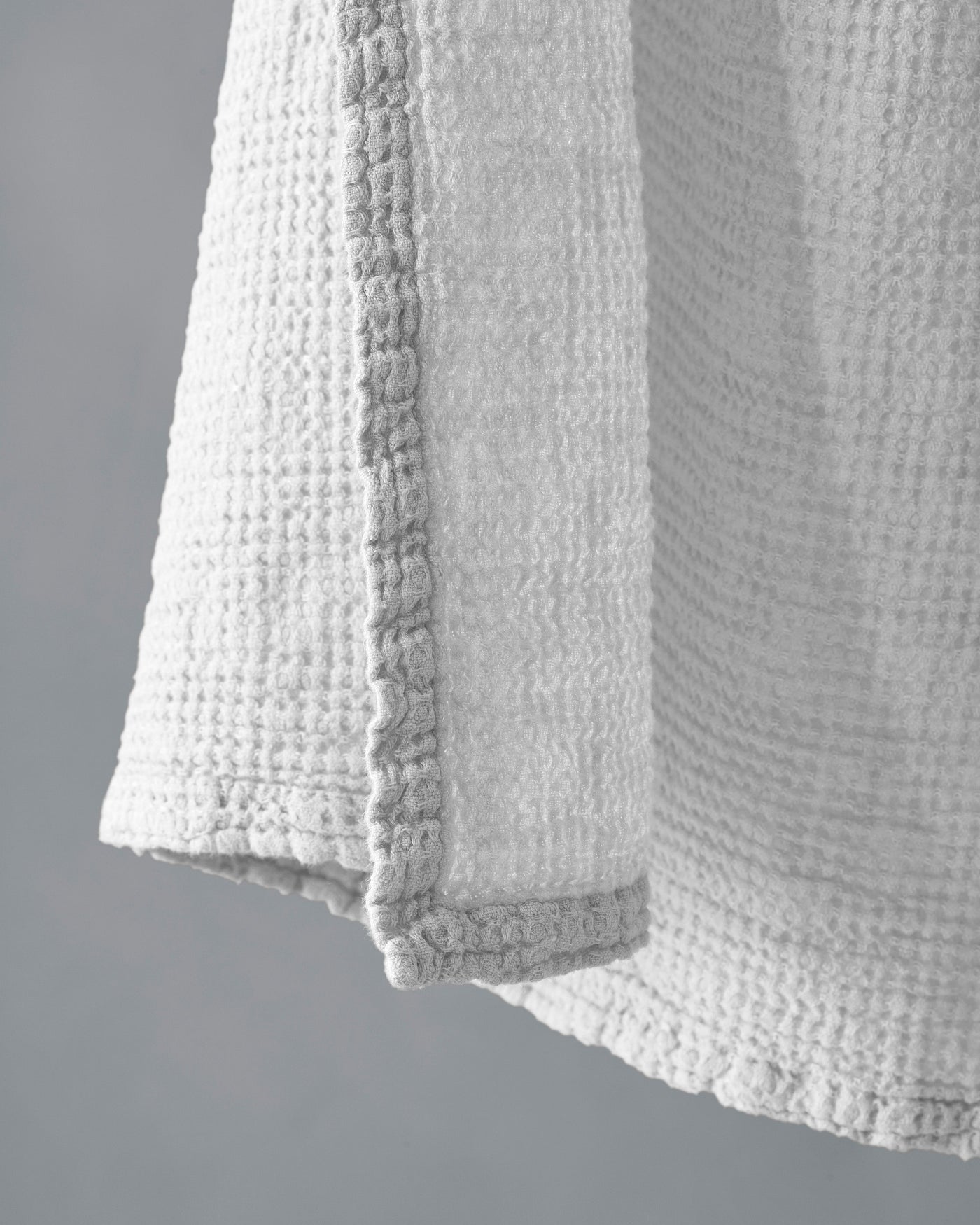 Close-up of Society Limonta Lipe New towel hem, ivory waffle-weave texture and looped edge detail.