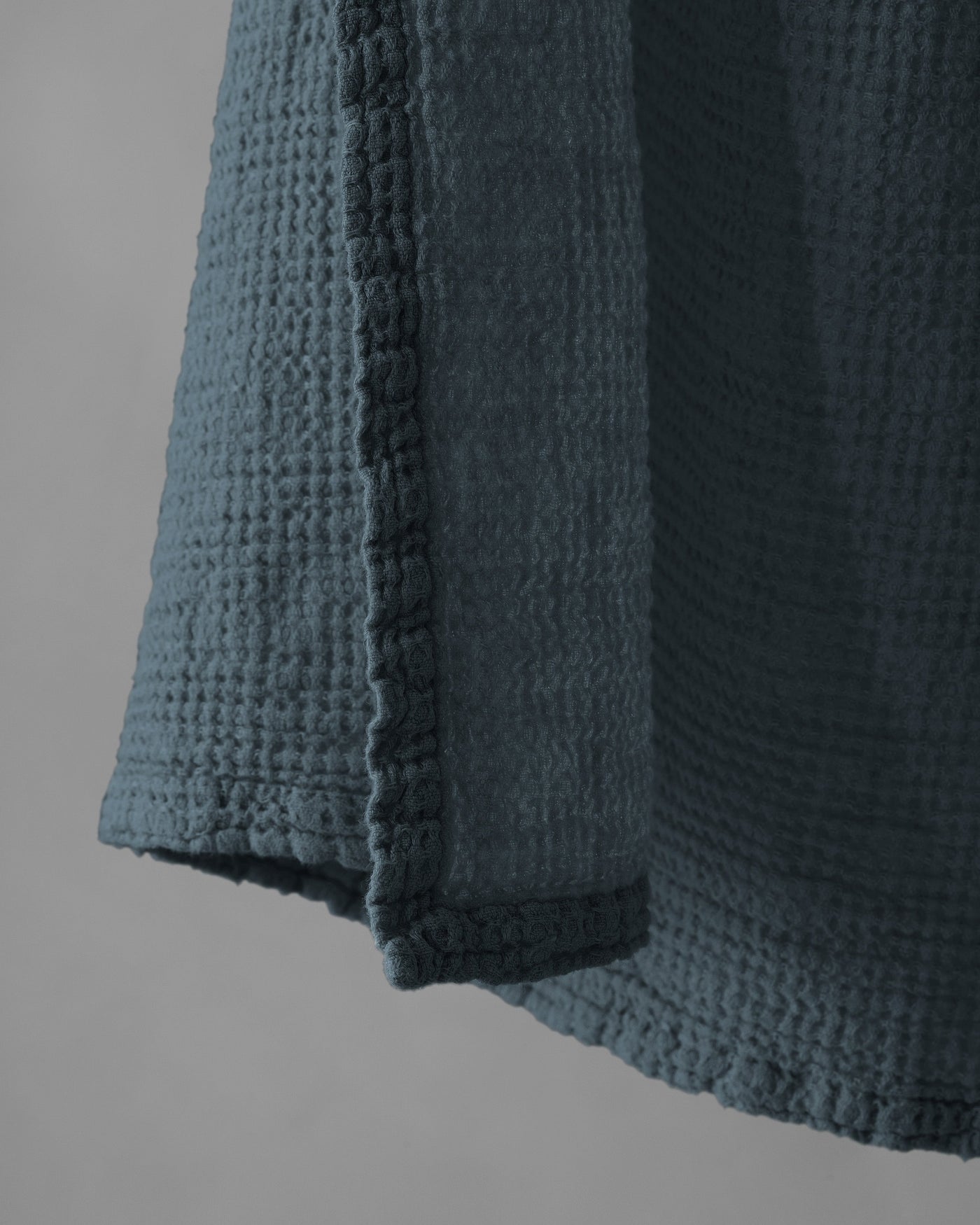 Close-up of Society Limonta Lipe New towel hem in slate blue waffle-weave cotton.