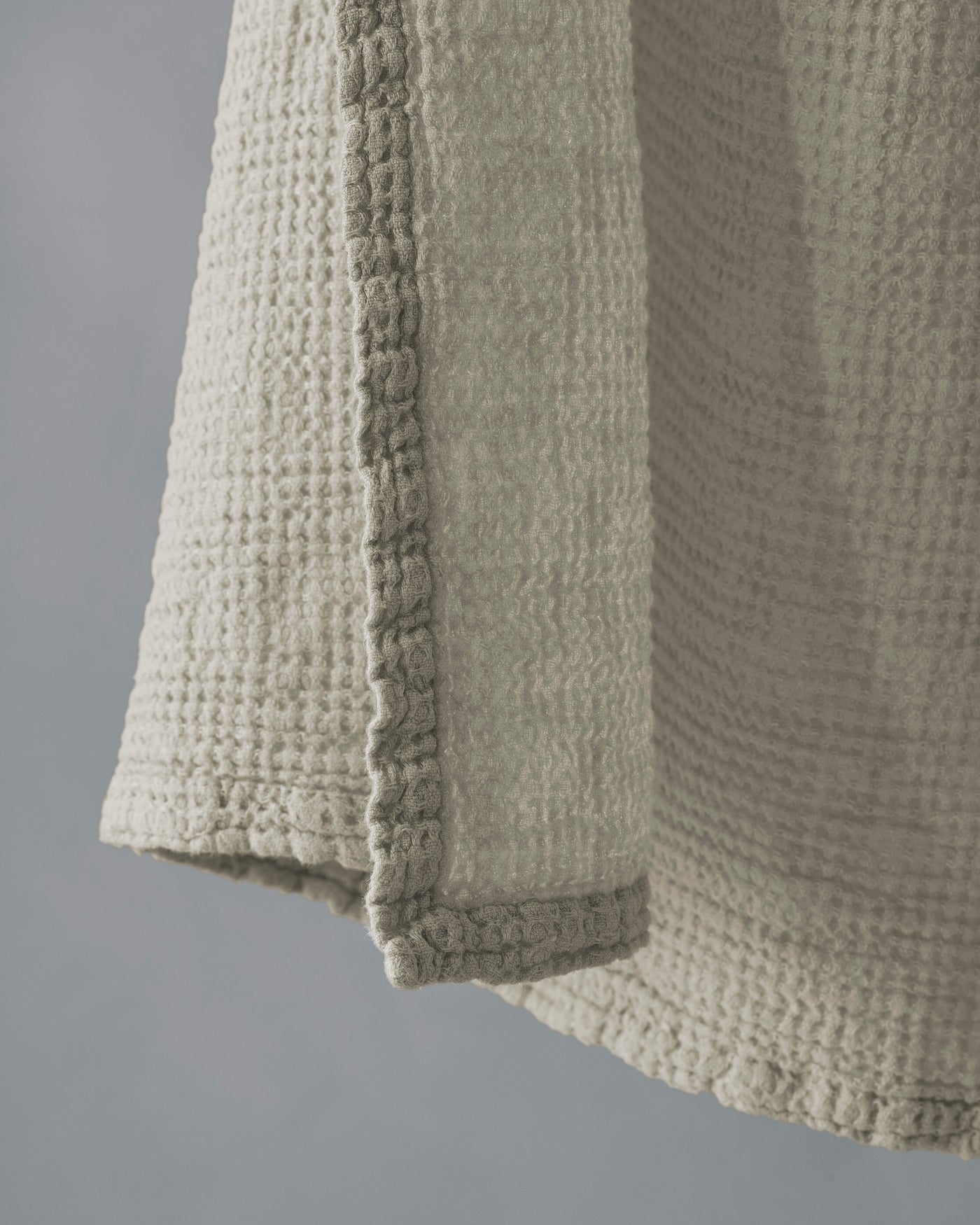 Close-up of Society Limonta Lipe New towel hem, showing textured waffle weave in sage.