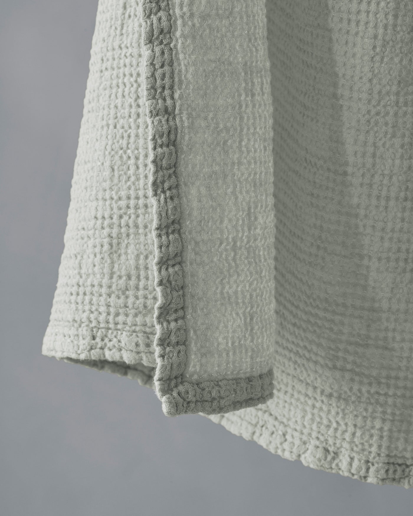 Close-up of Society Limonta Lipe New towel hem, sage waffle-weave texture detail.