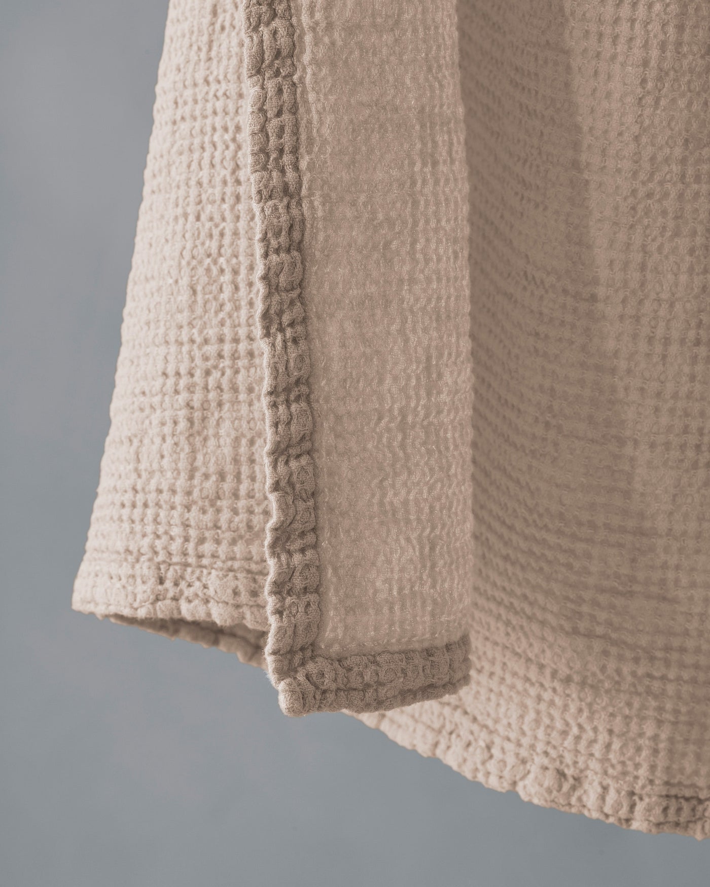 Close-up of Society Limonta Lipe New towel hem, showing waffle texture in sand.