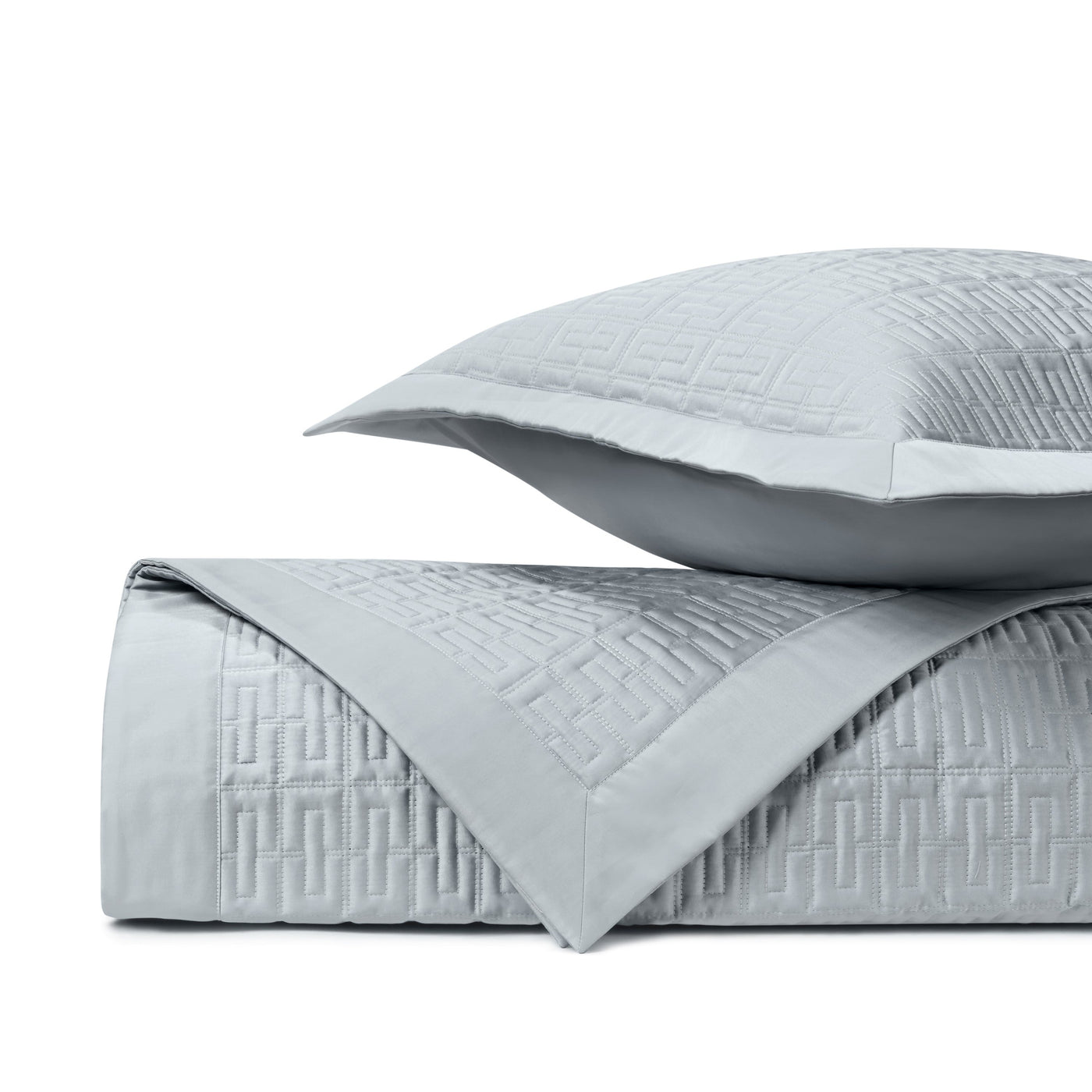 Close-up of Londres quilted satin in silver with geometric Greek key pattern.