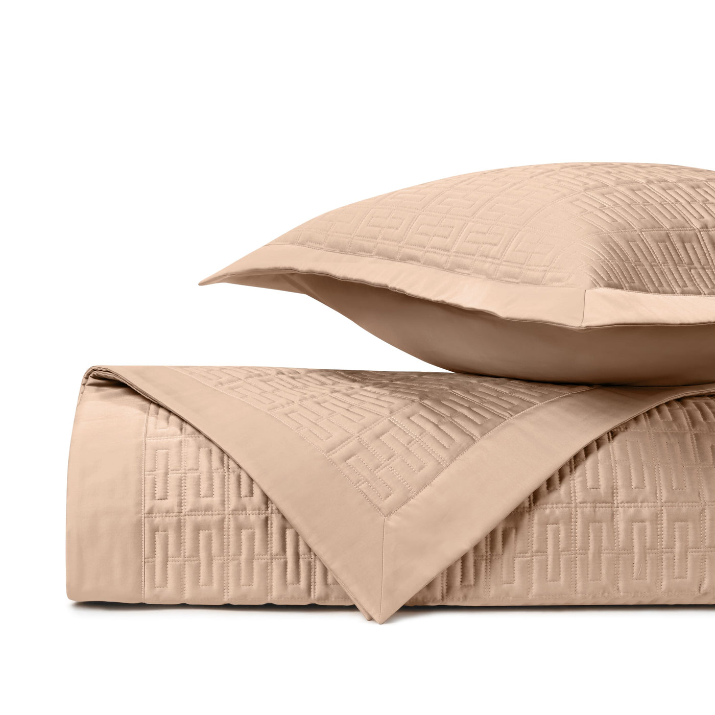 Close-up of Londres quilted coverlet in champagne with geometric Greek key pattern.
