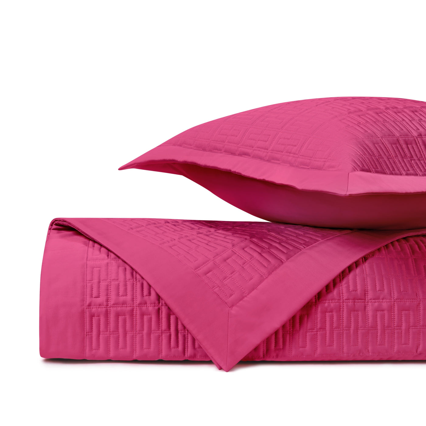 Folded fuchsia quilted coverlet showing geometric basket-weave pattern detail with matching sham.