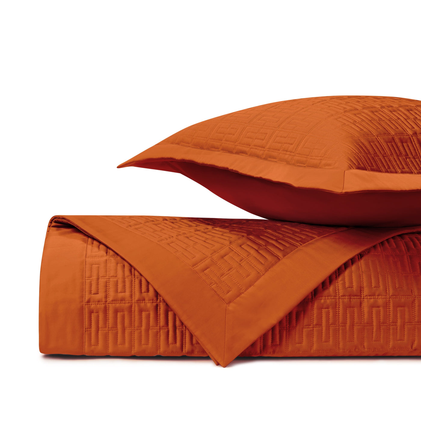 Close-up of Londres quilted satin in tangerine, showing geometric brick pattern detail.