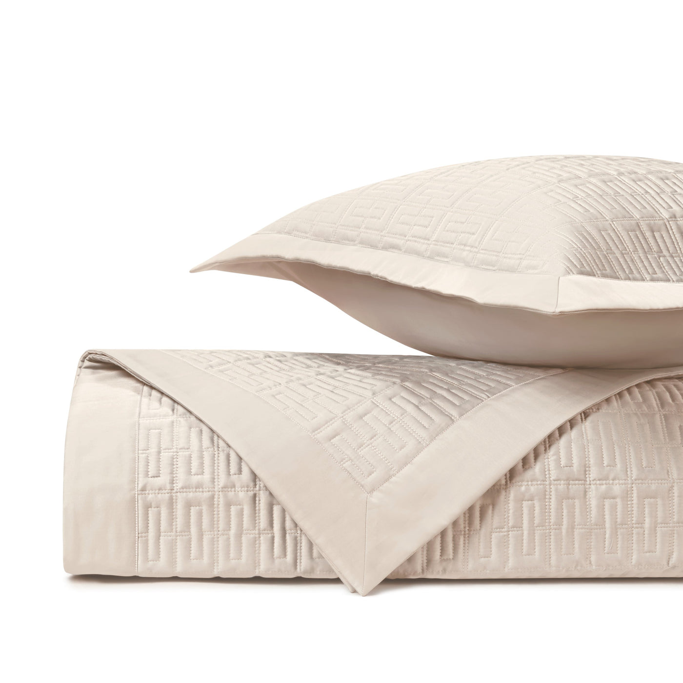 Close-up of Londres quilted texture in ivory with geometric Greek key pattern.