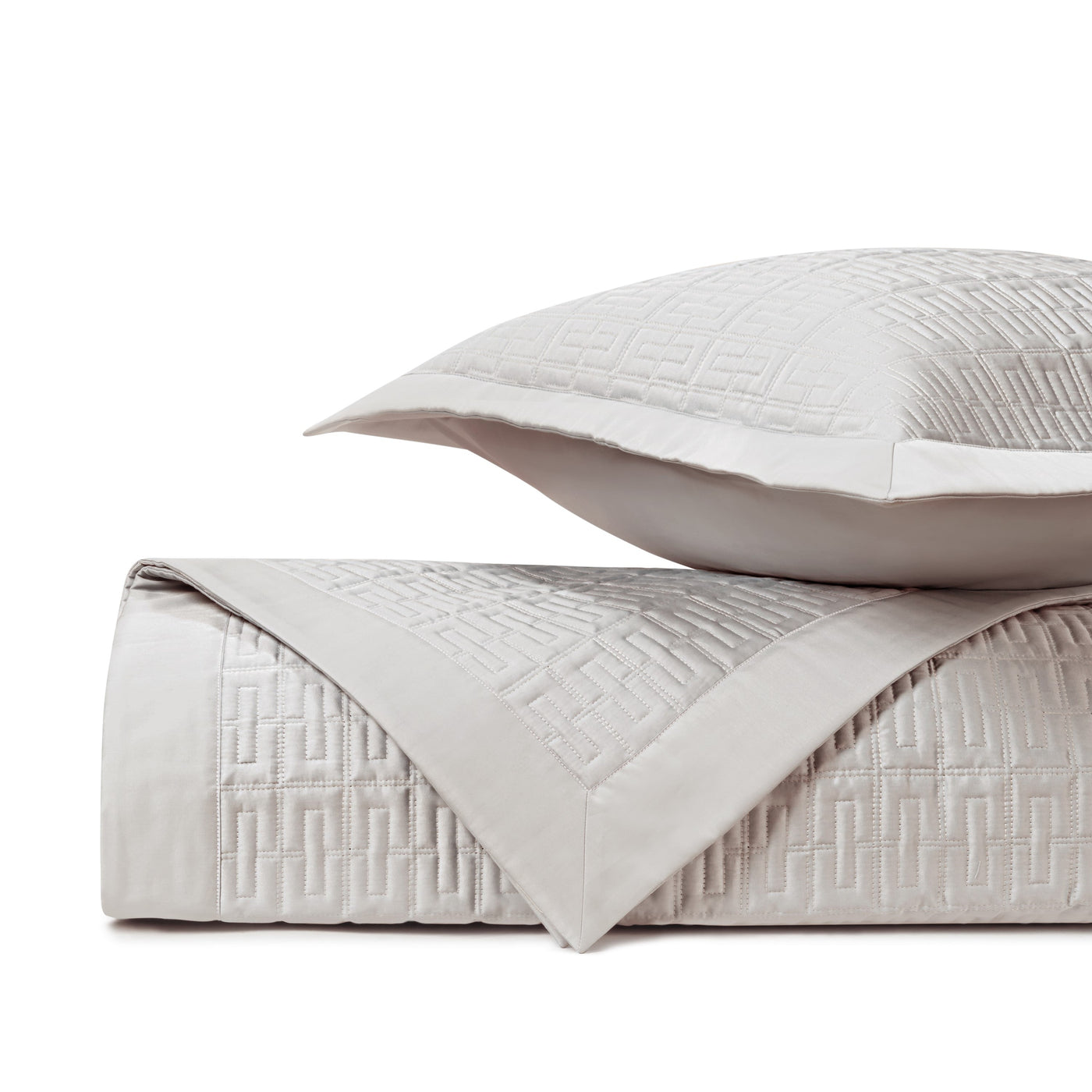 Close-up of Home Treasures Londres quilted texture in pearl with geometric Greek key pattern.