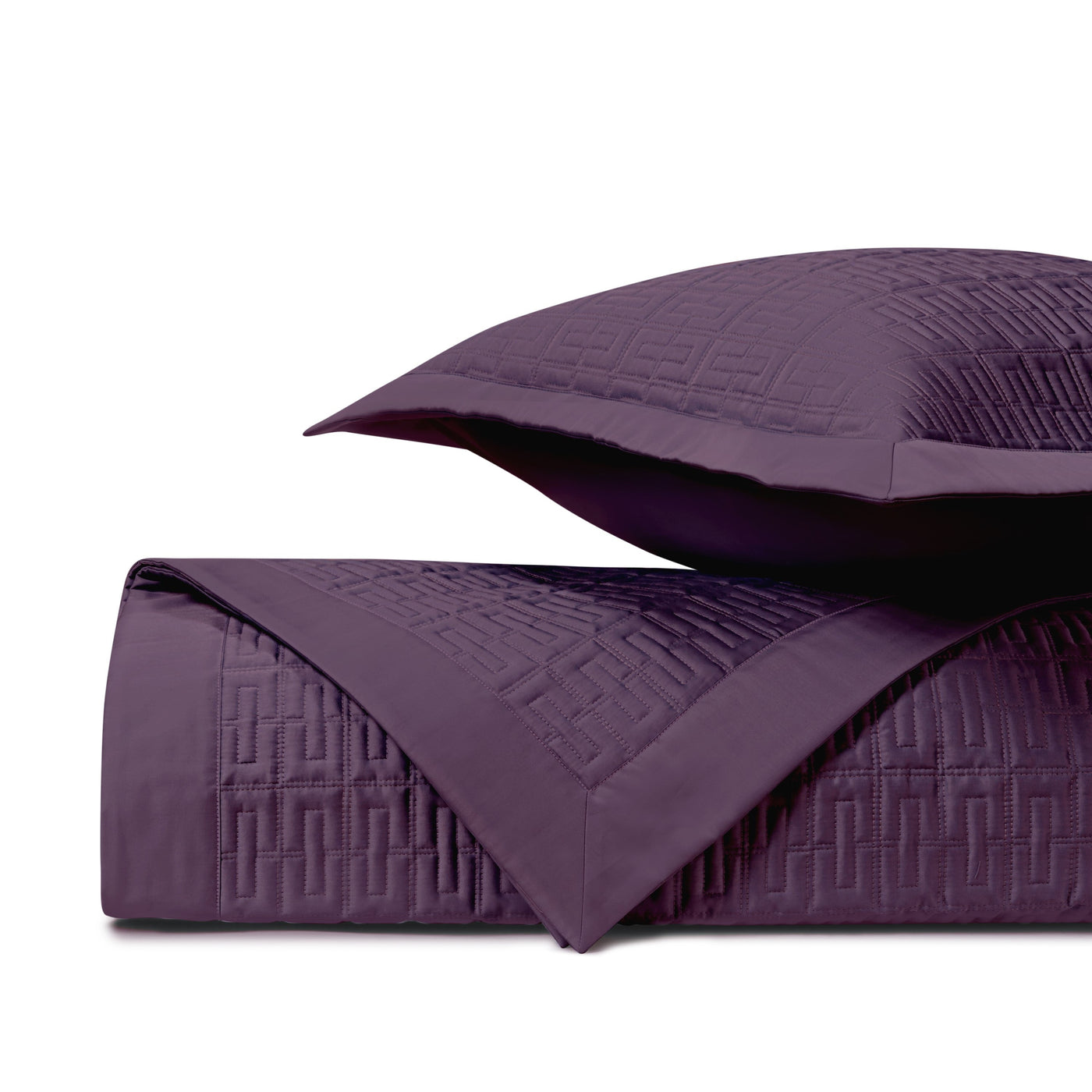 Close-up of amethyst quilted coverlet with geometric basket-weave stitching and matching sham.