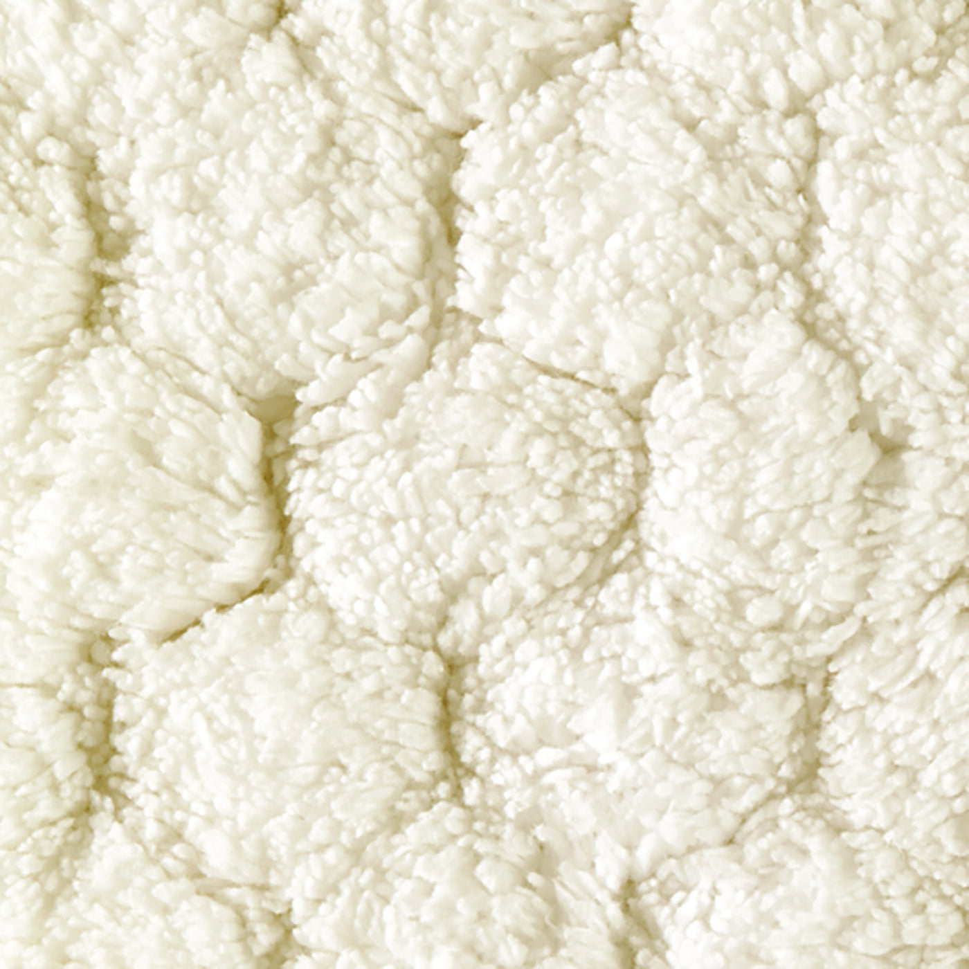 Close-up of ivory sculpted loop texture in a circular petal pattern.