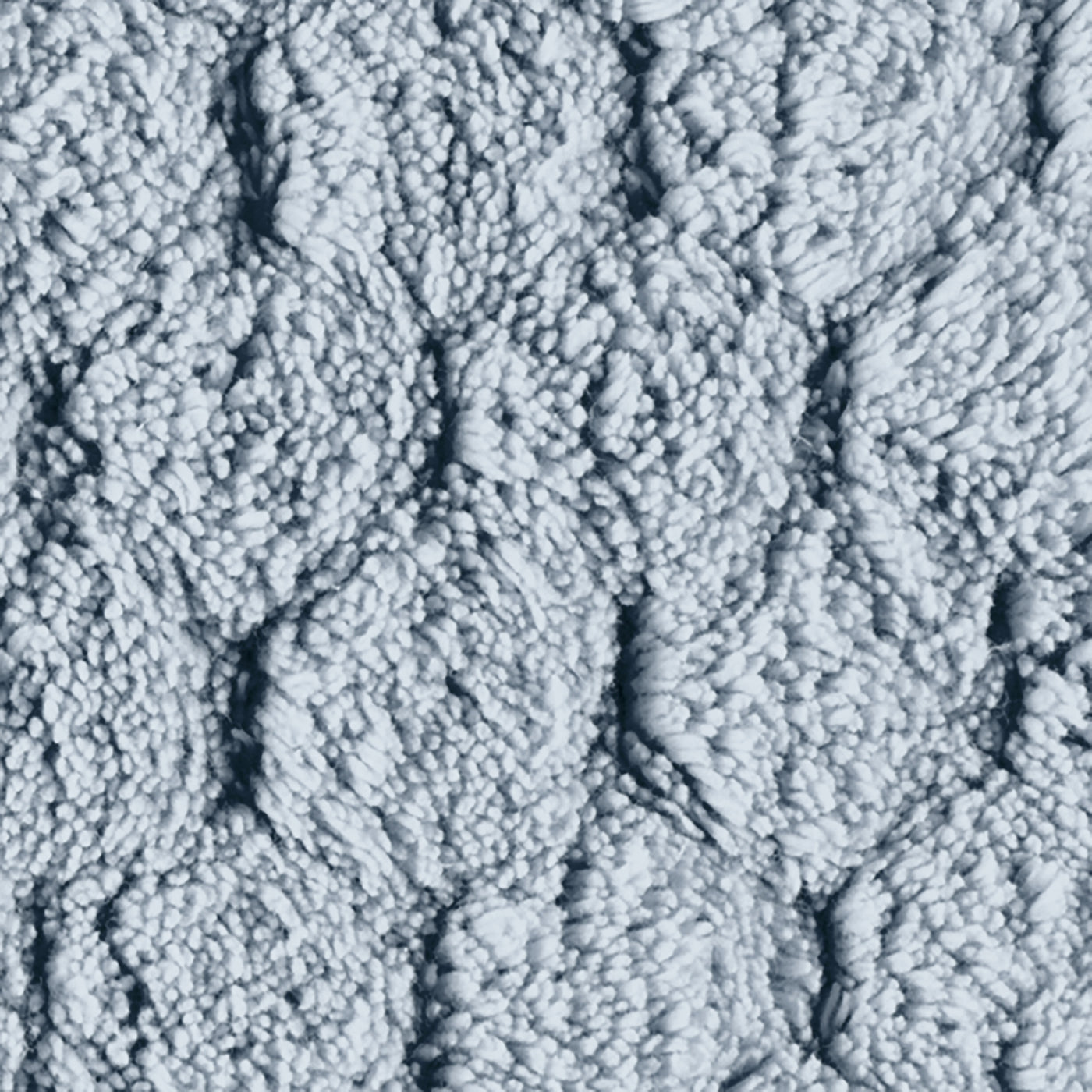 Close-up of powder blue textured cotton bath rug with raised diamond boucle weave.
