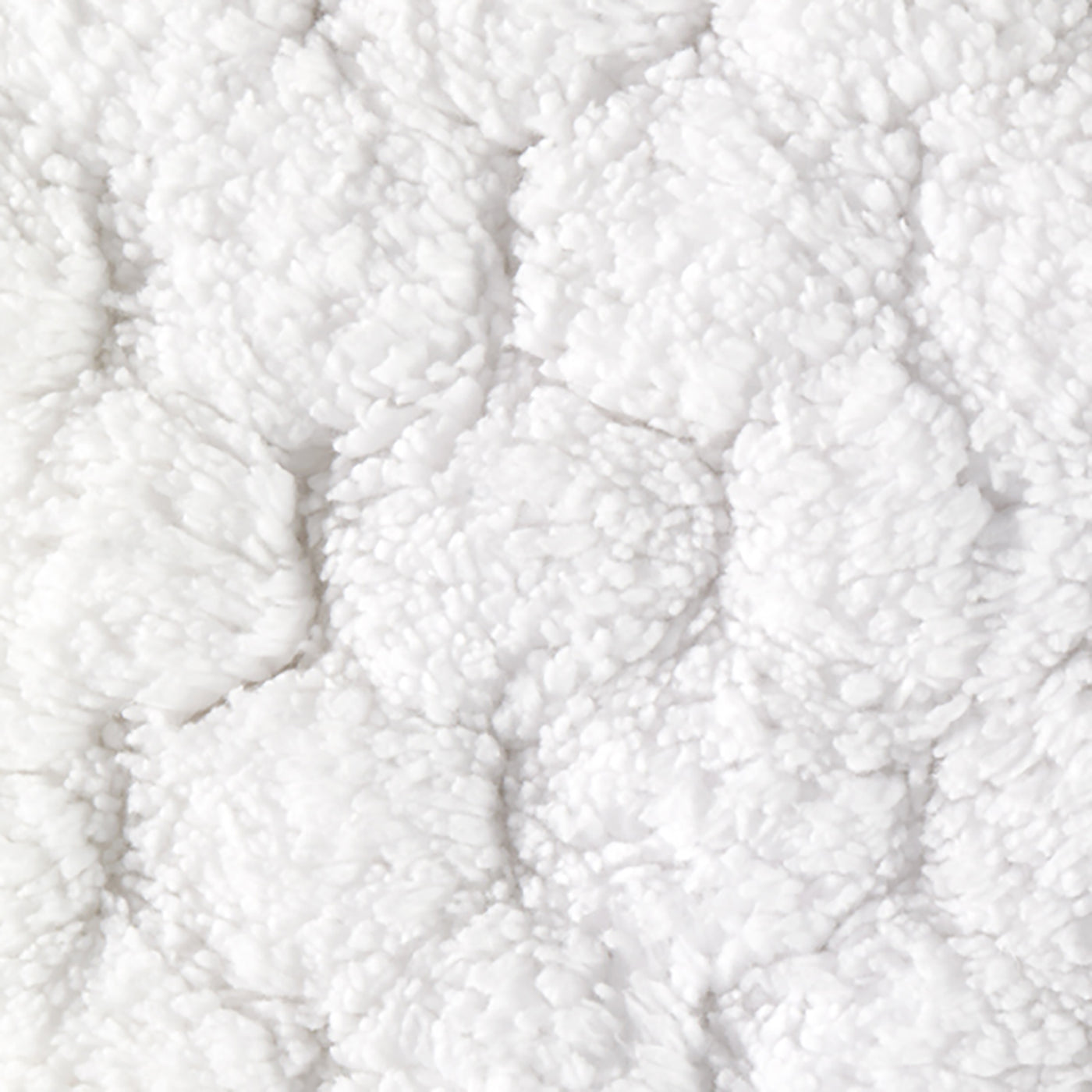 Close-up of Matouk Lotus bath rug showing tufted cotton loops in white honeycomb pattern.