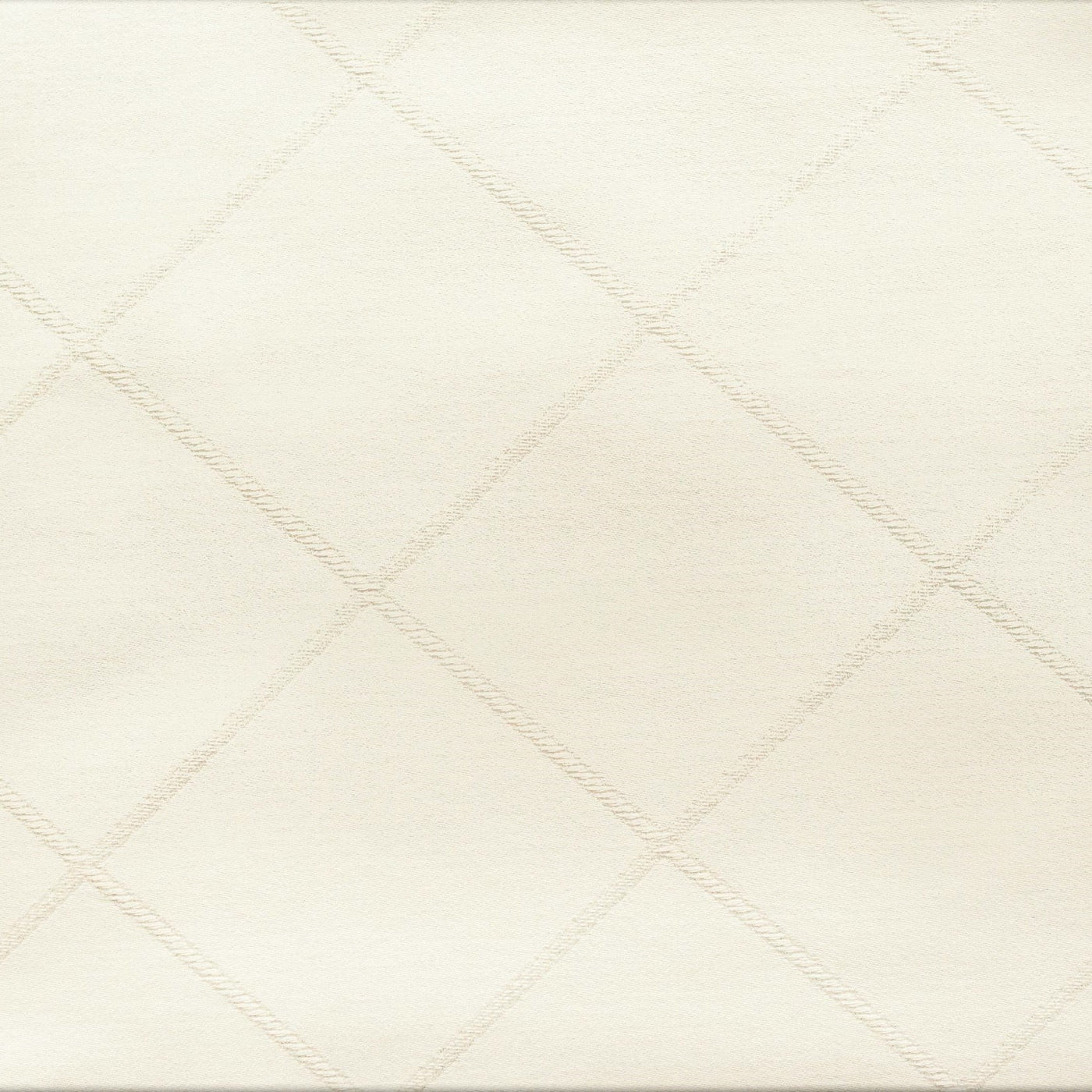 Close-up of ivory cotton pillow sham with woven diamond trellis pattern.