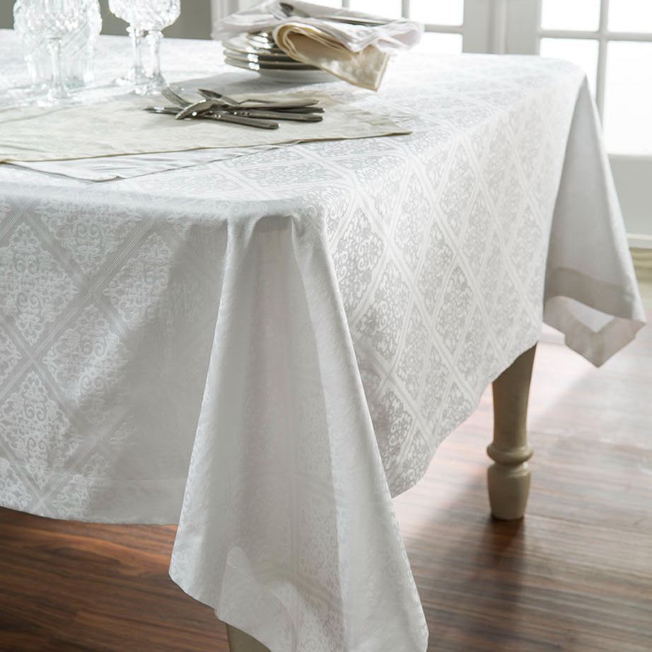 Home Treasures Luciana ivory damask tablecloth on dining table with place settings.