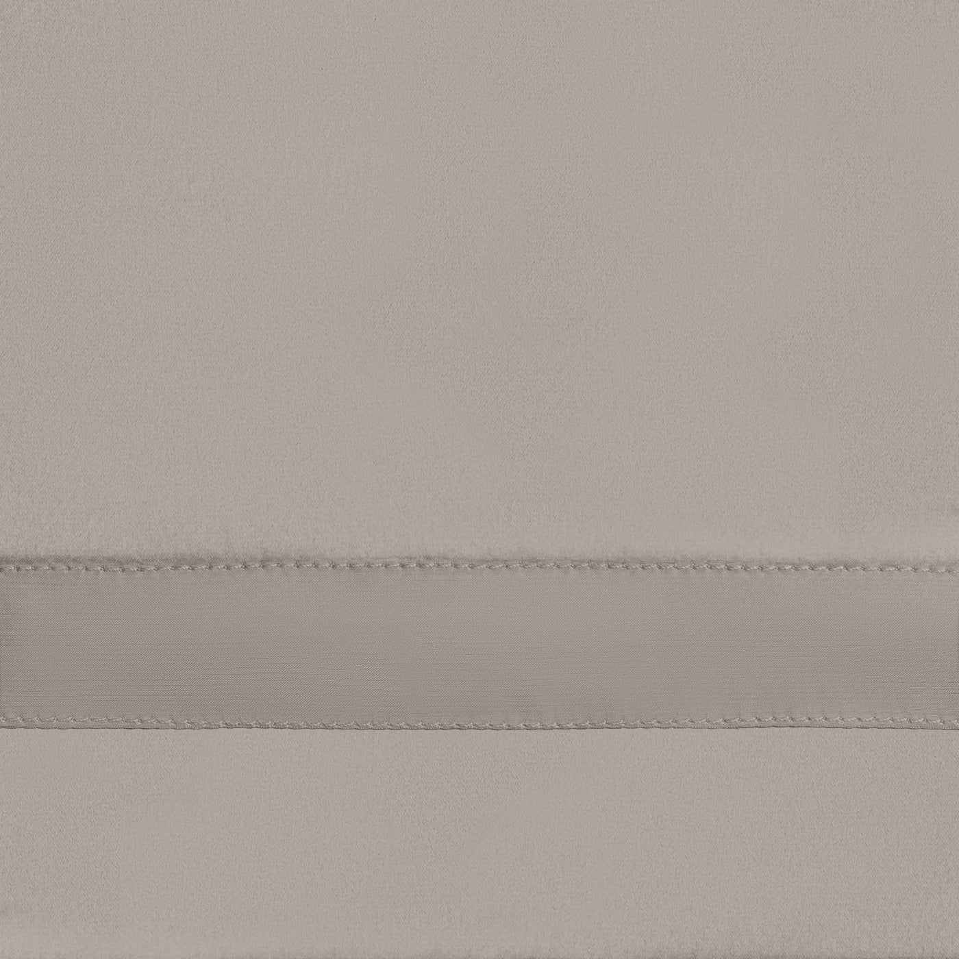 Close-up of a pebble satin fitted sheet showing a double-stitched seam detail.
