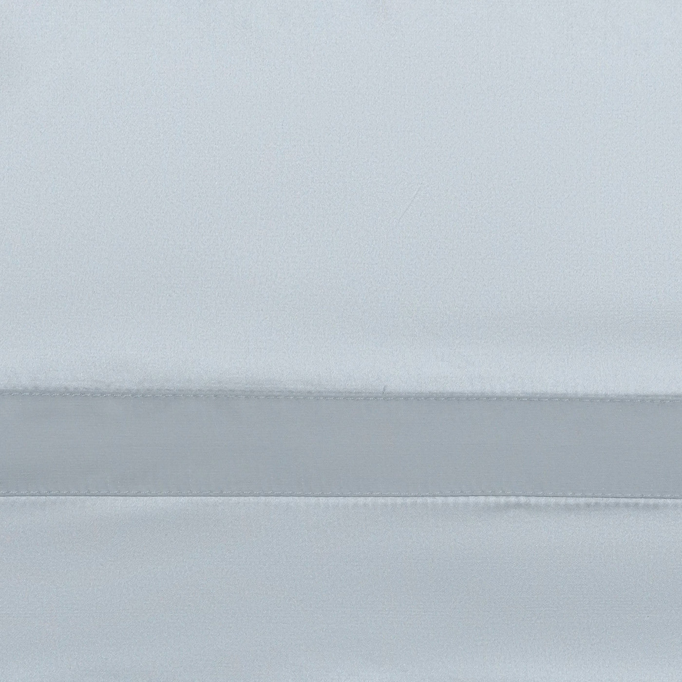 Close-up of mist sateen fabric with a satin border and fine stitching detail.