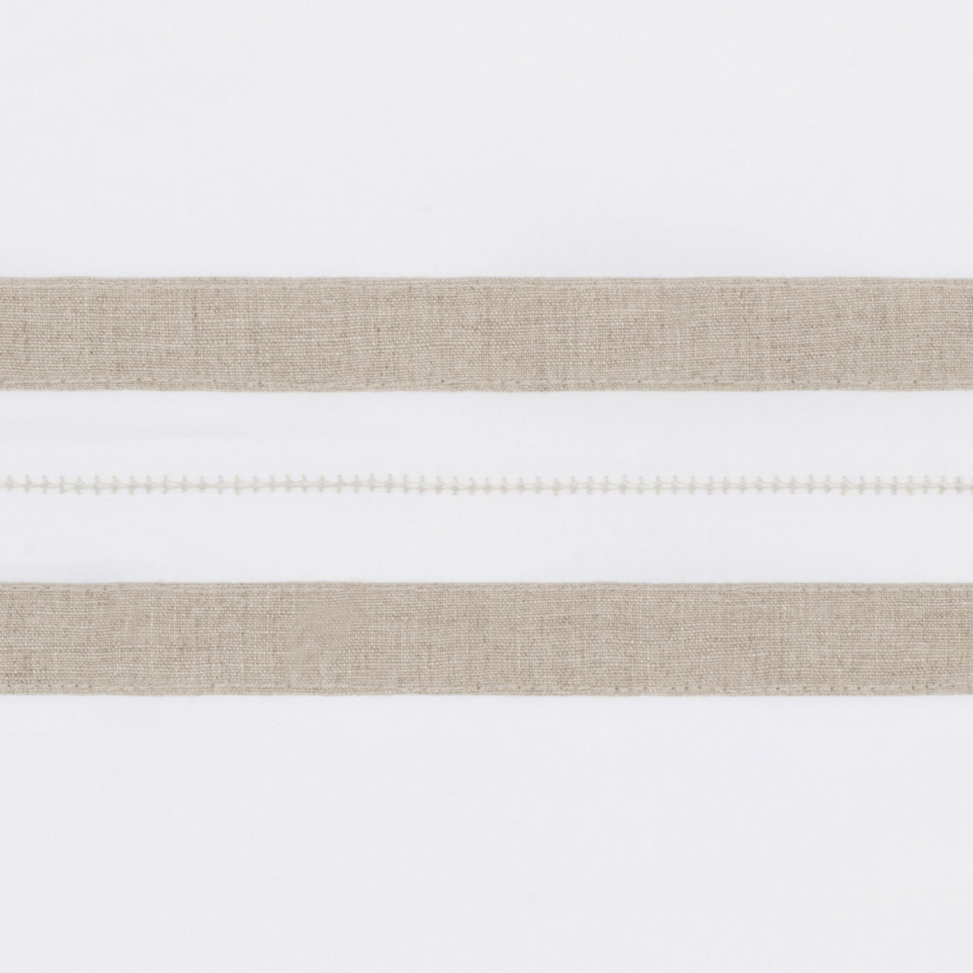 Close-up of natural linen border stripes with delicate ladder hemstitch detail on white fabric.