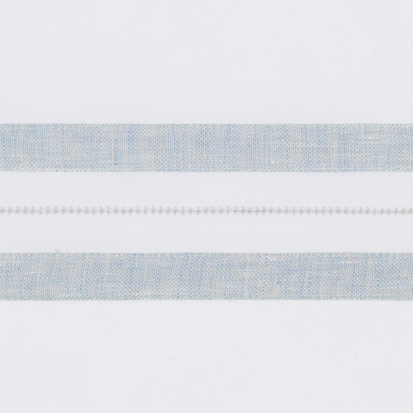 Close-up of pale blue woven stripe border with ladder hemstitch detail on white linen.