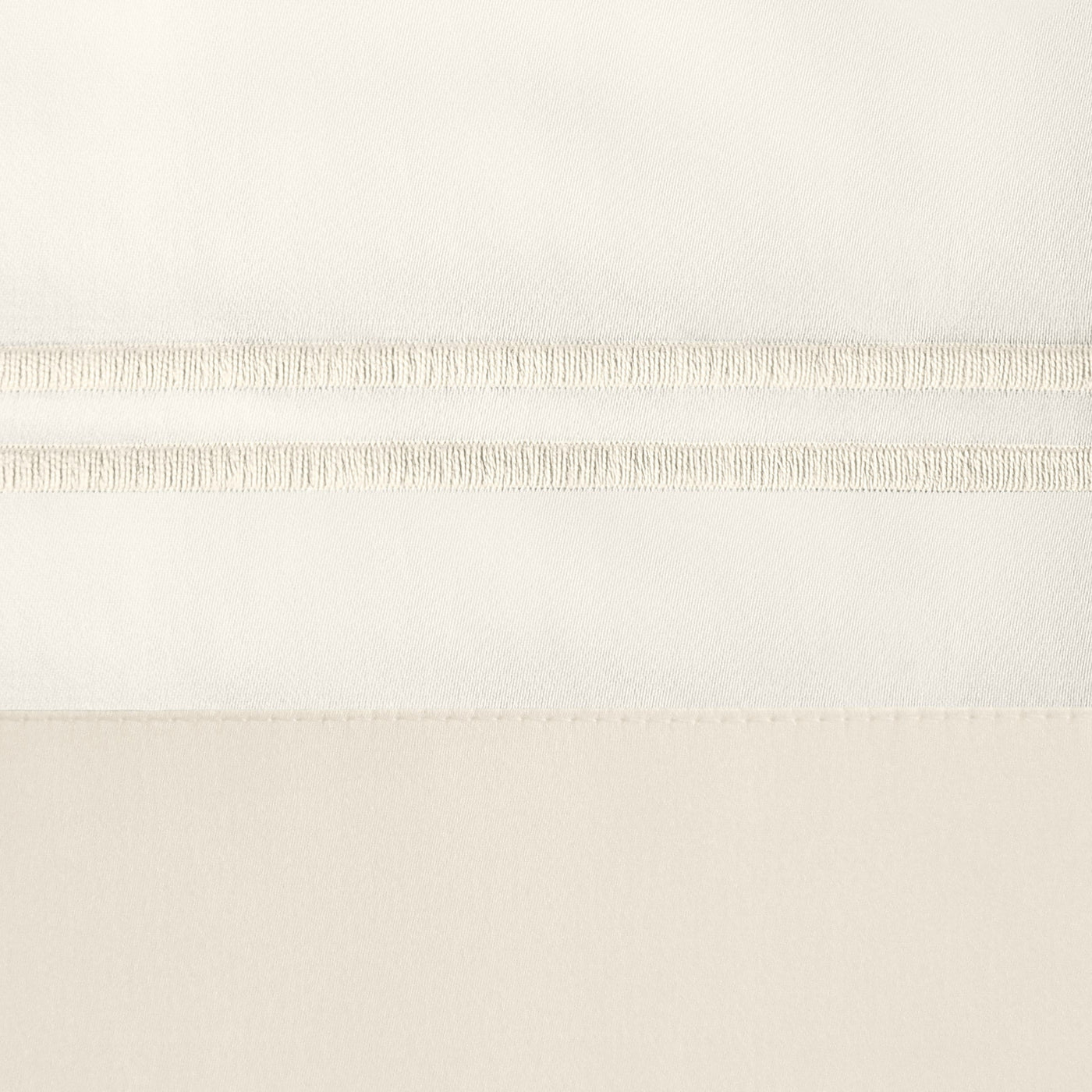 Close-up of ivory cotton pillowcase with tonal ladder stitch hem detail.