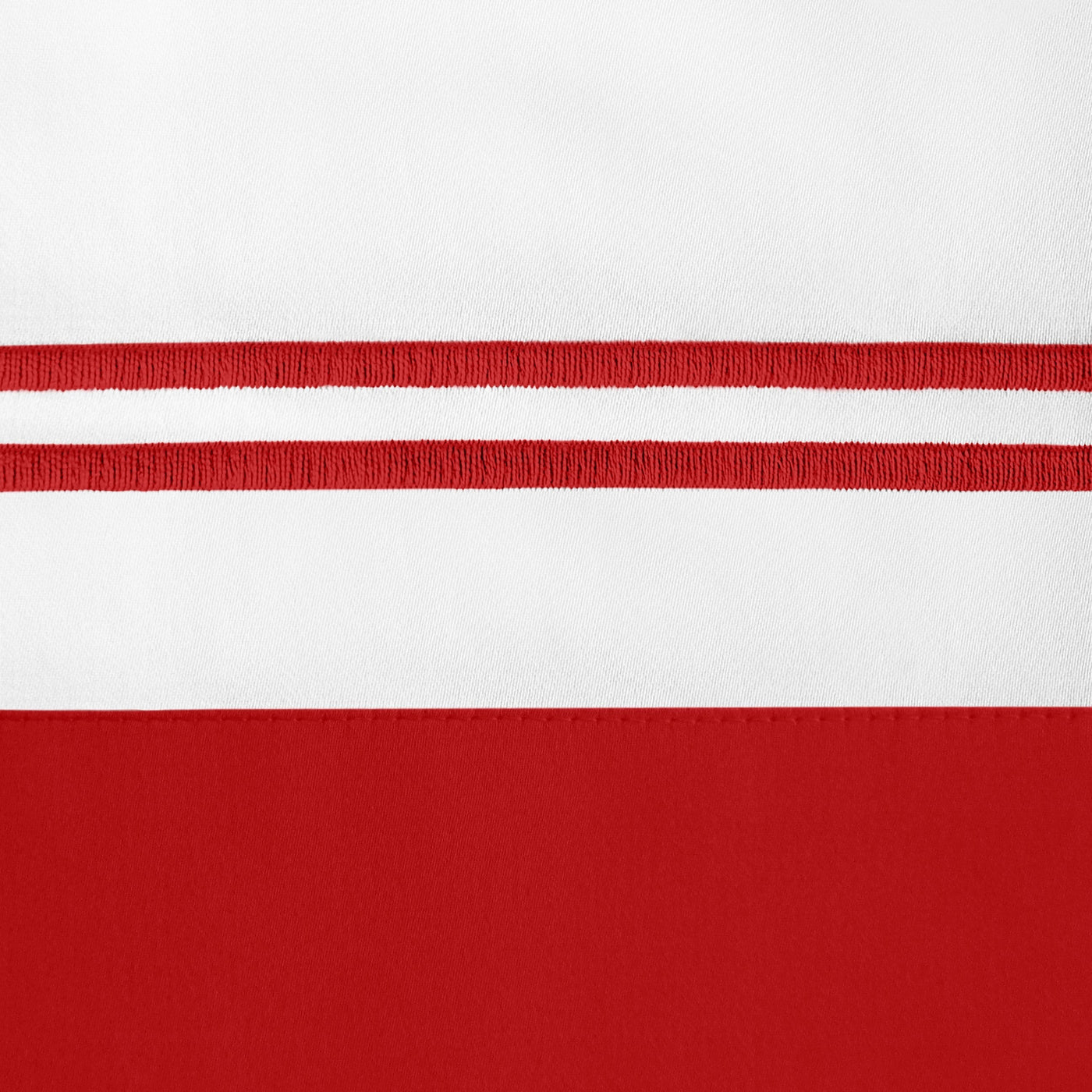 Close-up of crimson double-stripe embroidery detail on white linen pillowcase hem.
