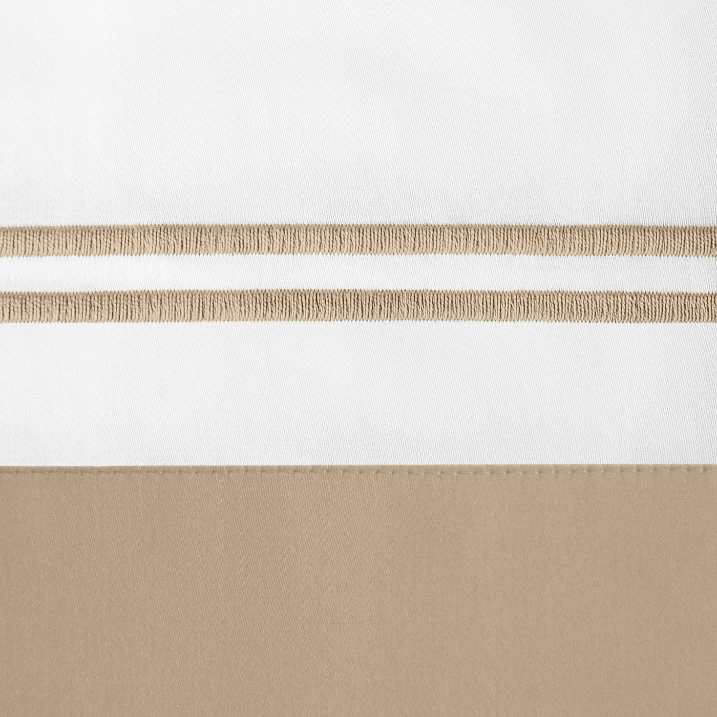 Close-up of white and dune colorblock linen with parallel woven stripe embroidery detail.