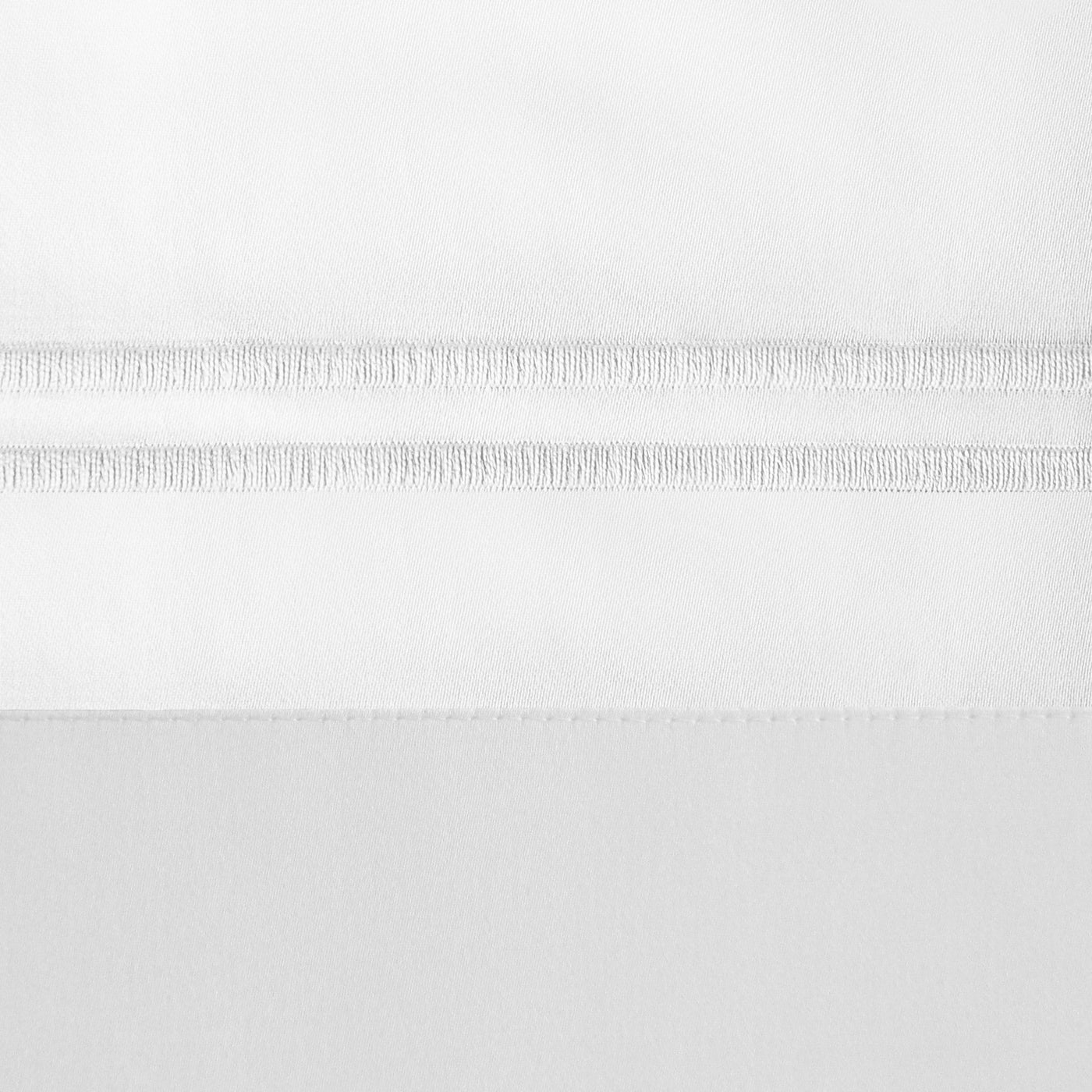 Close-up of white Marco pillowcase hem with delicate woven ladder stitching detail.