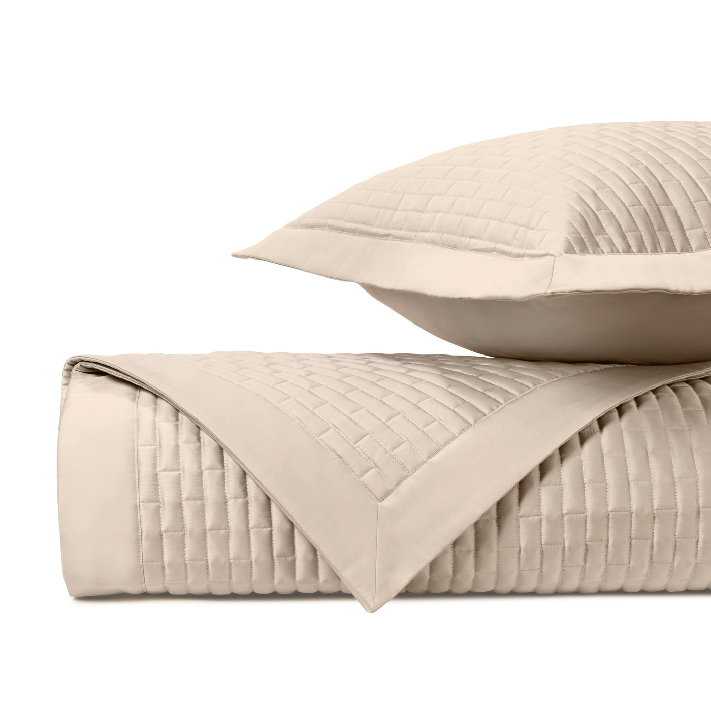 Close-up of Home Treasures Mason quilted coverlet in ivory, showing basket-weave stitching detail.