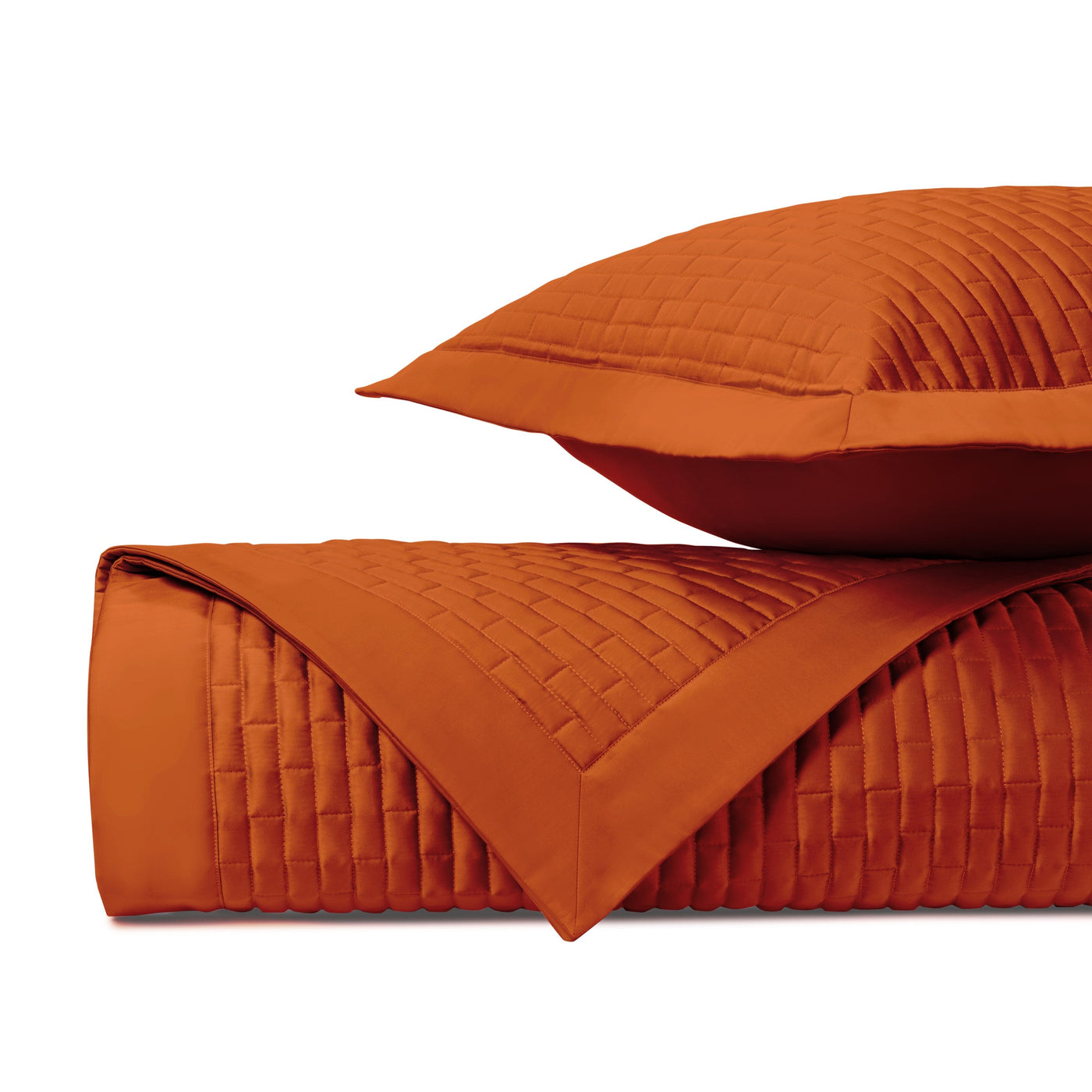Close-up of Home Treasures Mason quilted texture in burnt orange with basket-weave stitching.