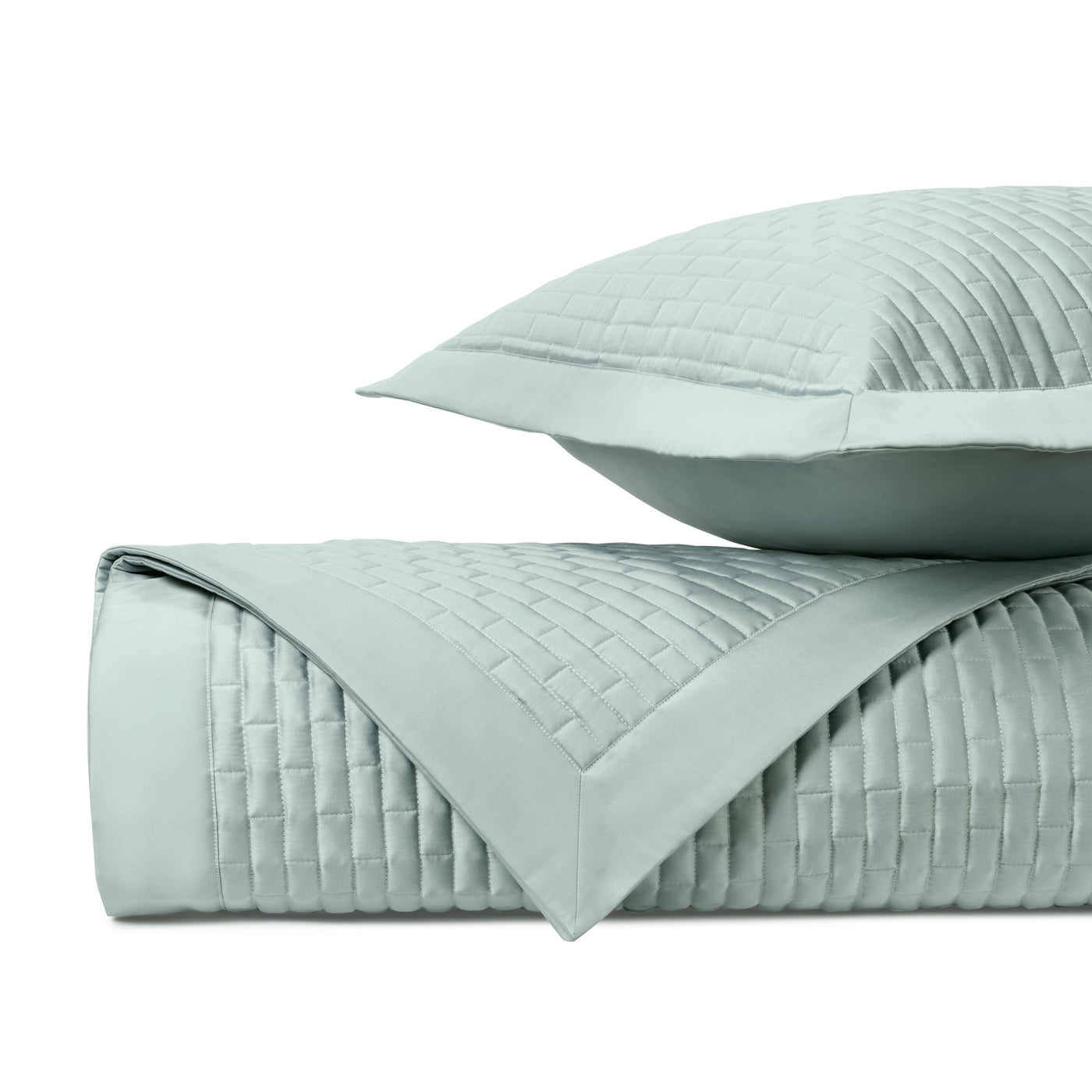 Close-up of Home Treasures Mason quilted coverlet in pale aqua with grid-stitched texture.