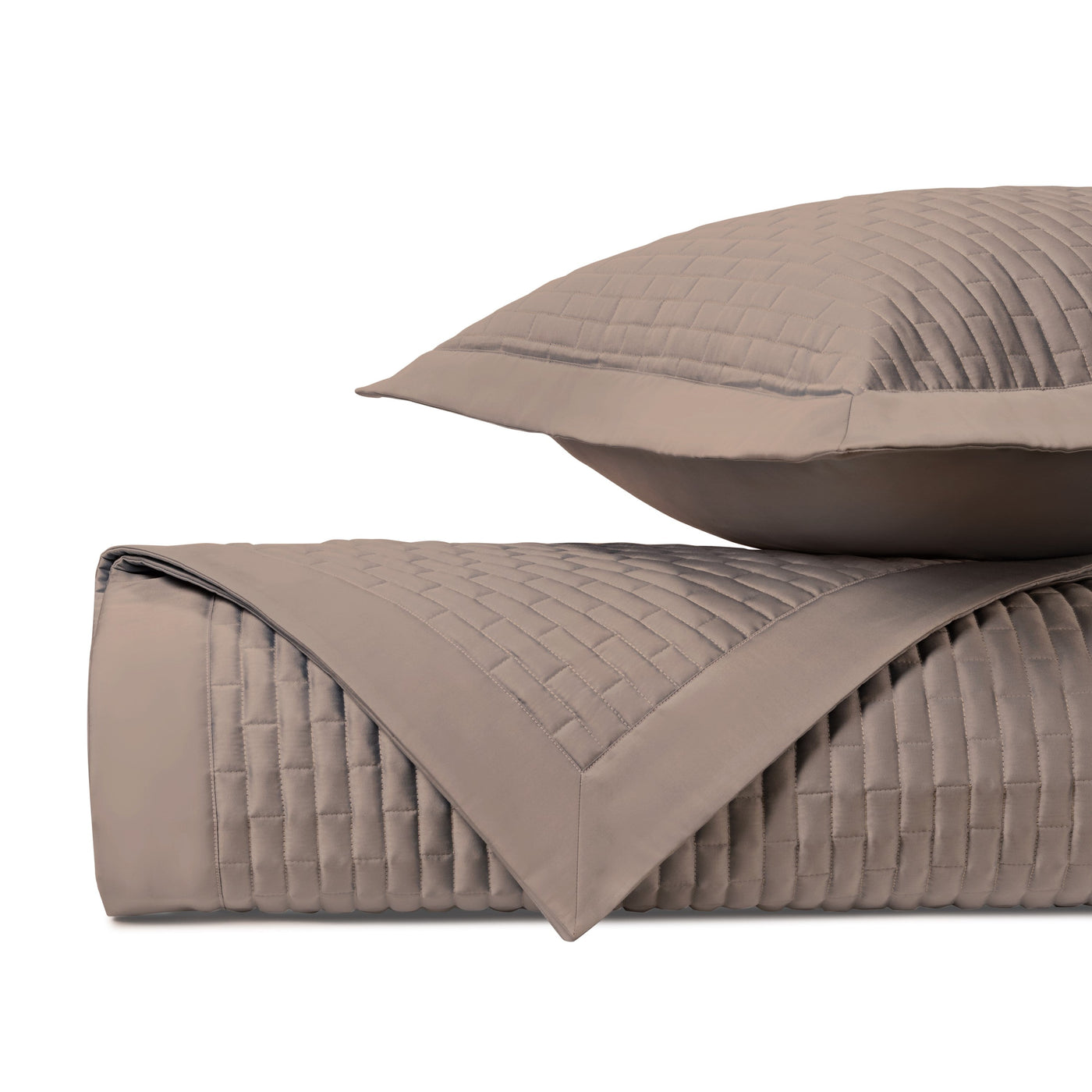 Close-up of Mason quilted satin in mink, showing basket-weave stitch pattern and folded edge.