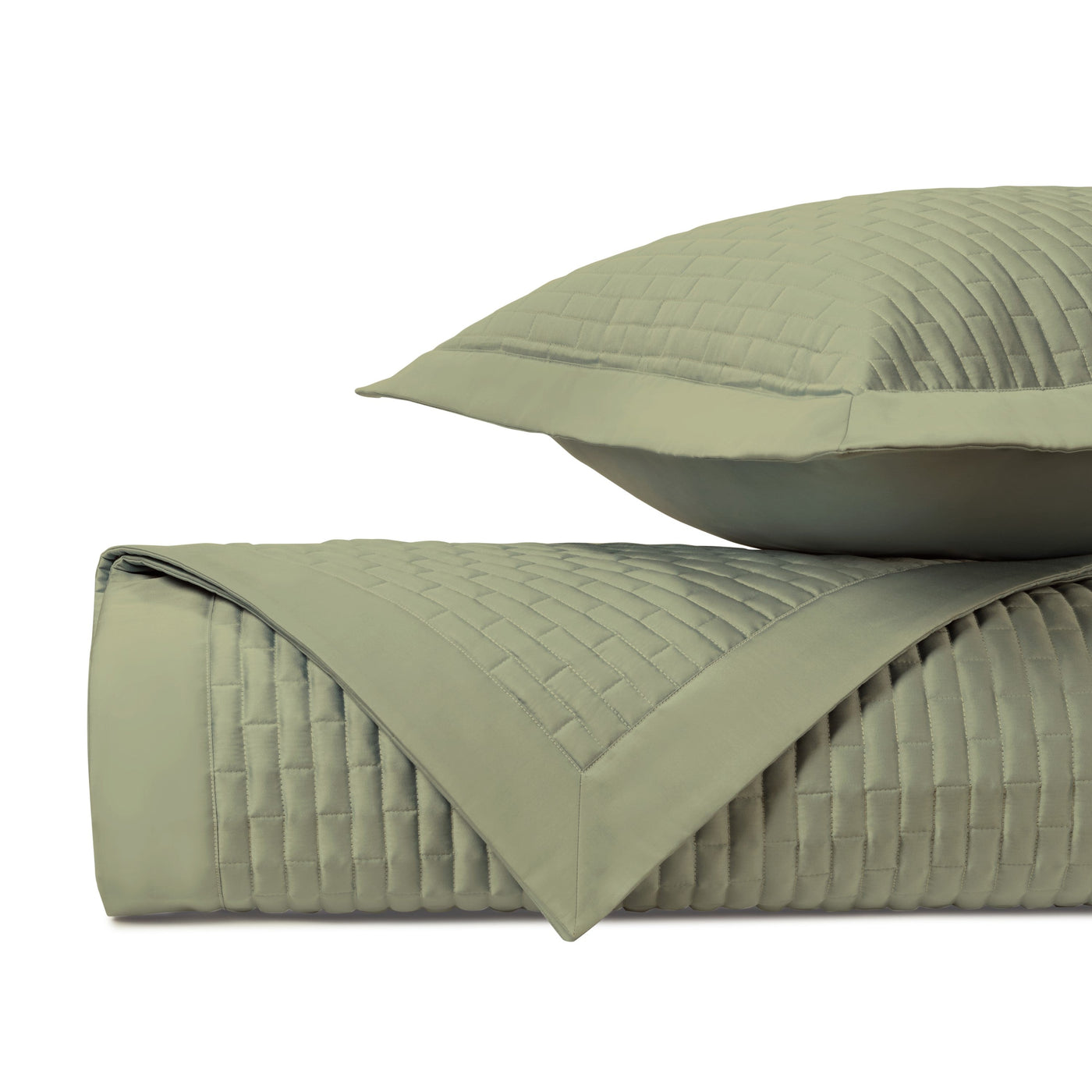 Close-up of sage green quilted satin with basket-weave stitching pattern.