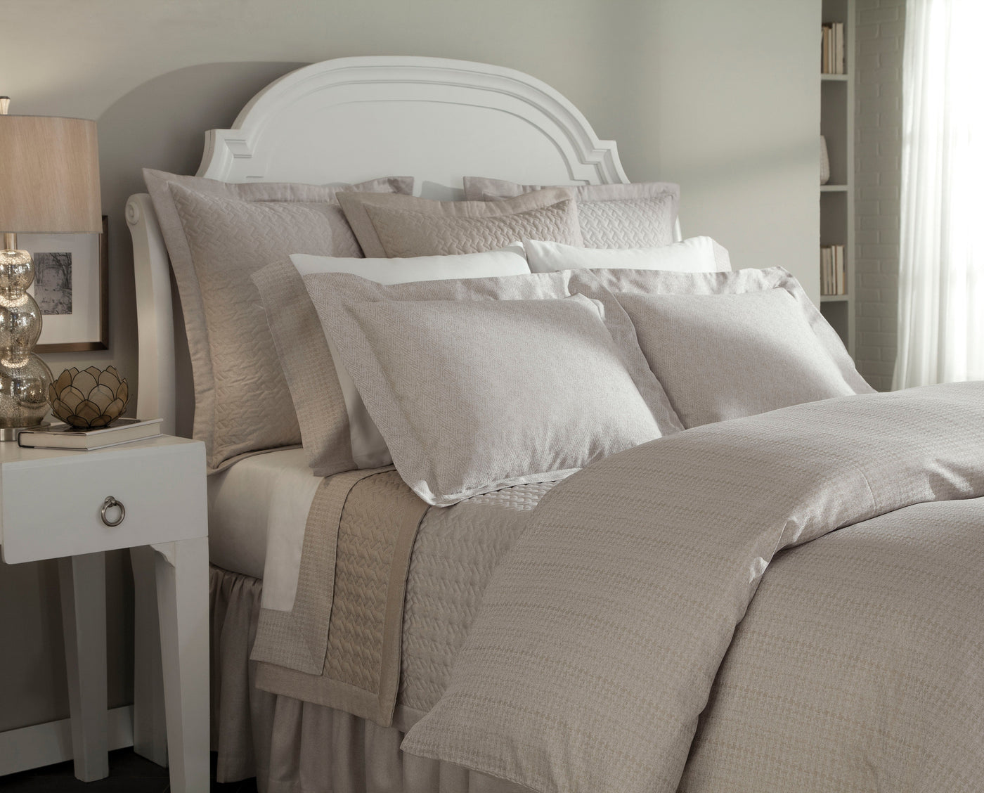 Mayfair bedding in taupe and ivory tones styled on a made bed with layered pillows.