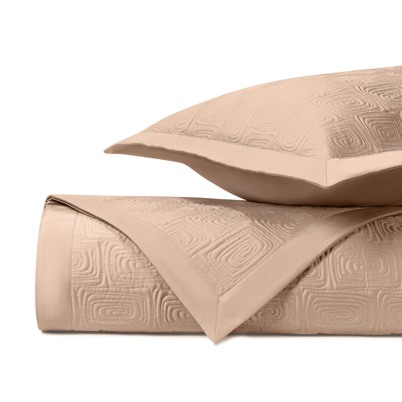 Close-up of Home Treasures Maze quilted coverlet in champagne with geometric embossed pattern.