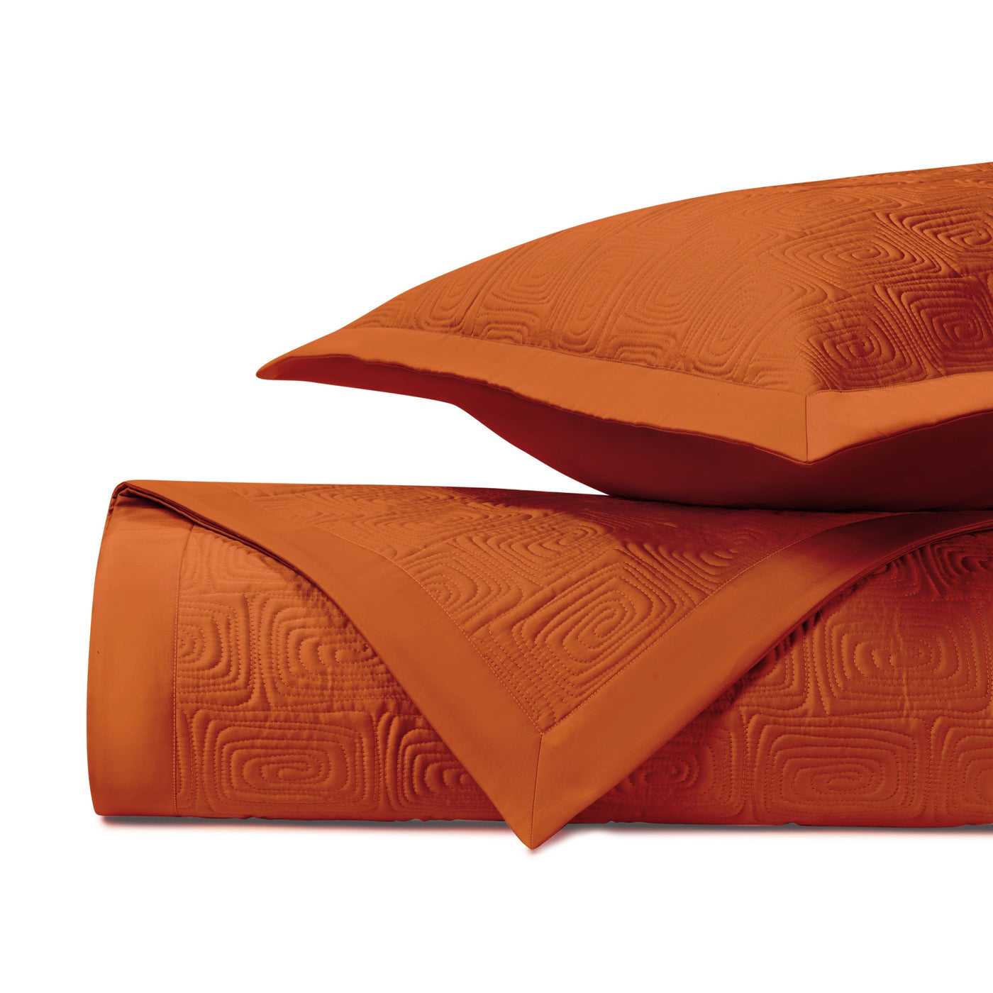 Close-up of Home Treasures Maze quilted fabric in tangerine with geometric embossed pattern.