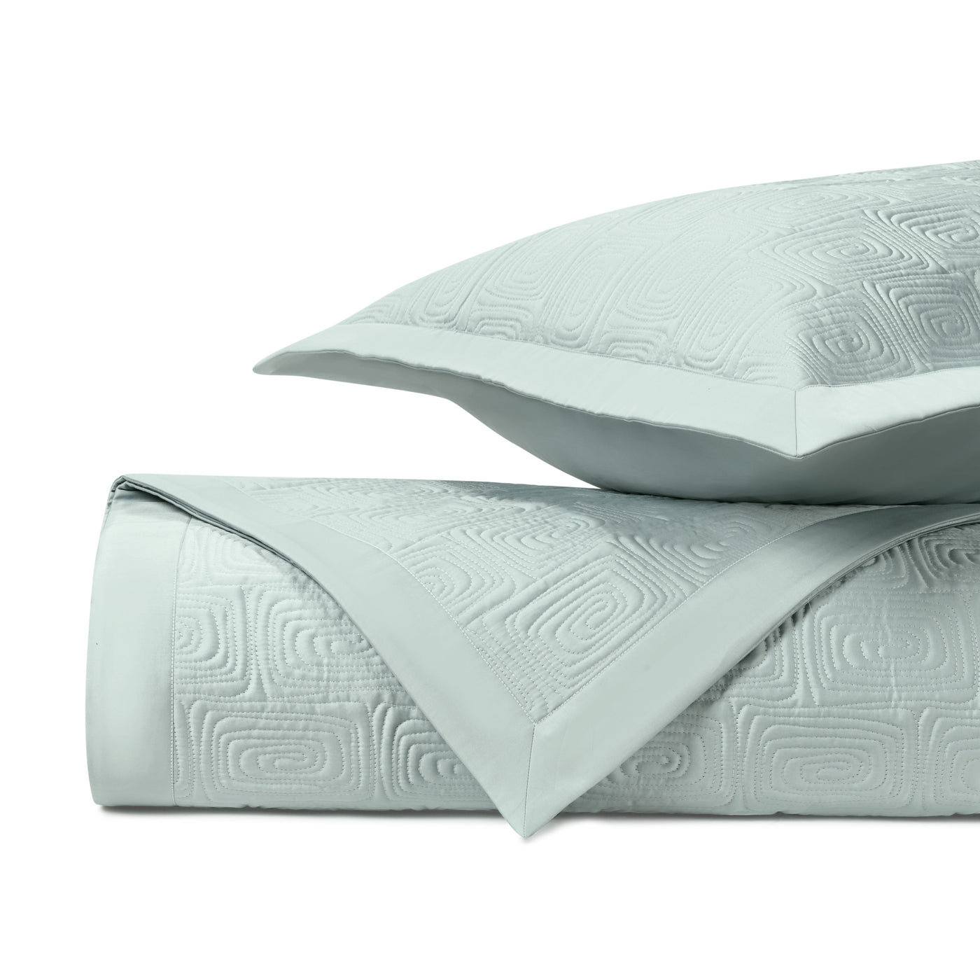 Close-up of Home Treasures Maze quilted coverlet in pale aqua with geometric relief pattern.