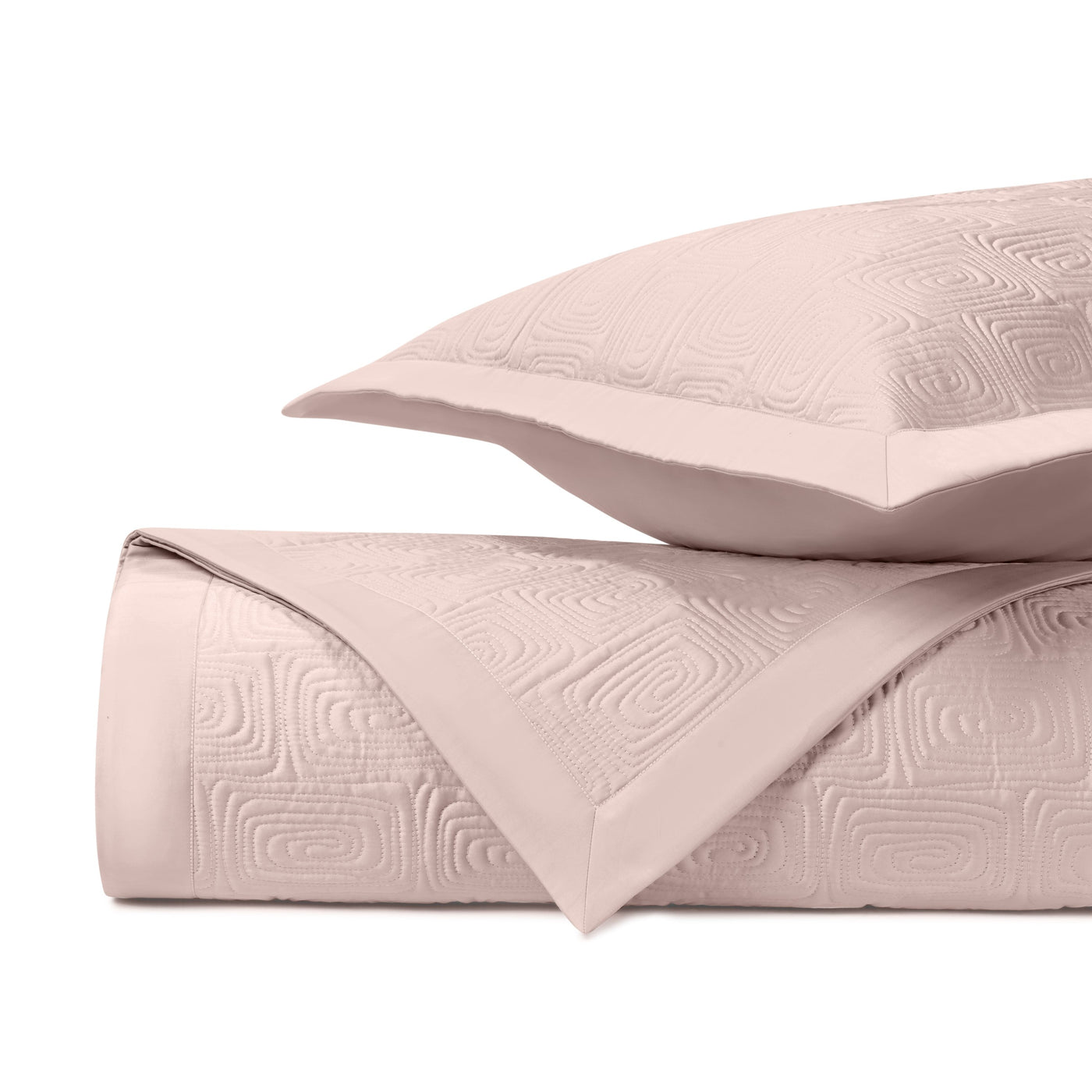 Close-up of blush Maze quilted texture with geometric relief pattern and satin border trim.
