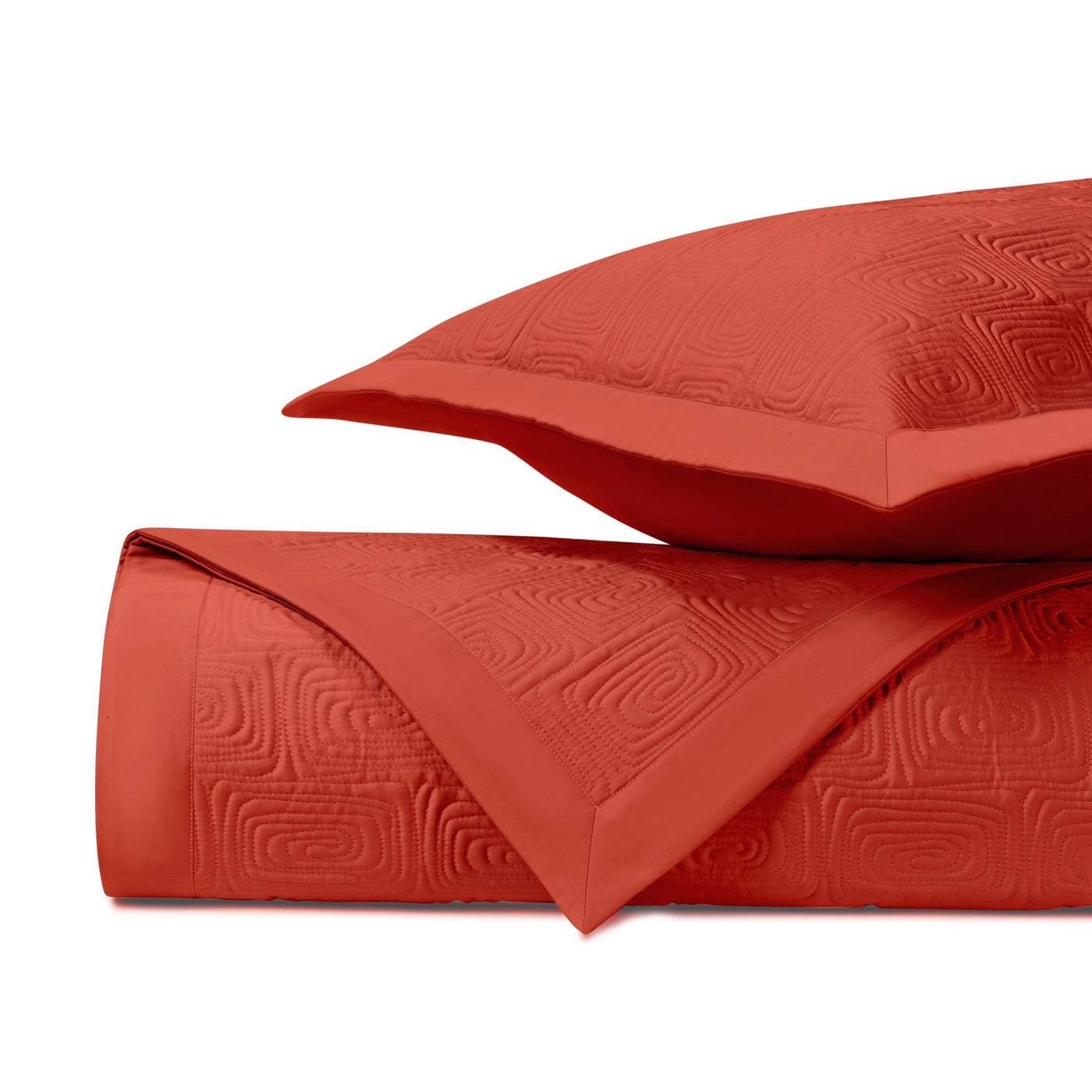 Close-up of tomato red quilted matelassé fabric with geometric maze pattern.