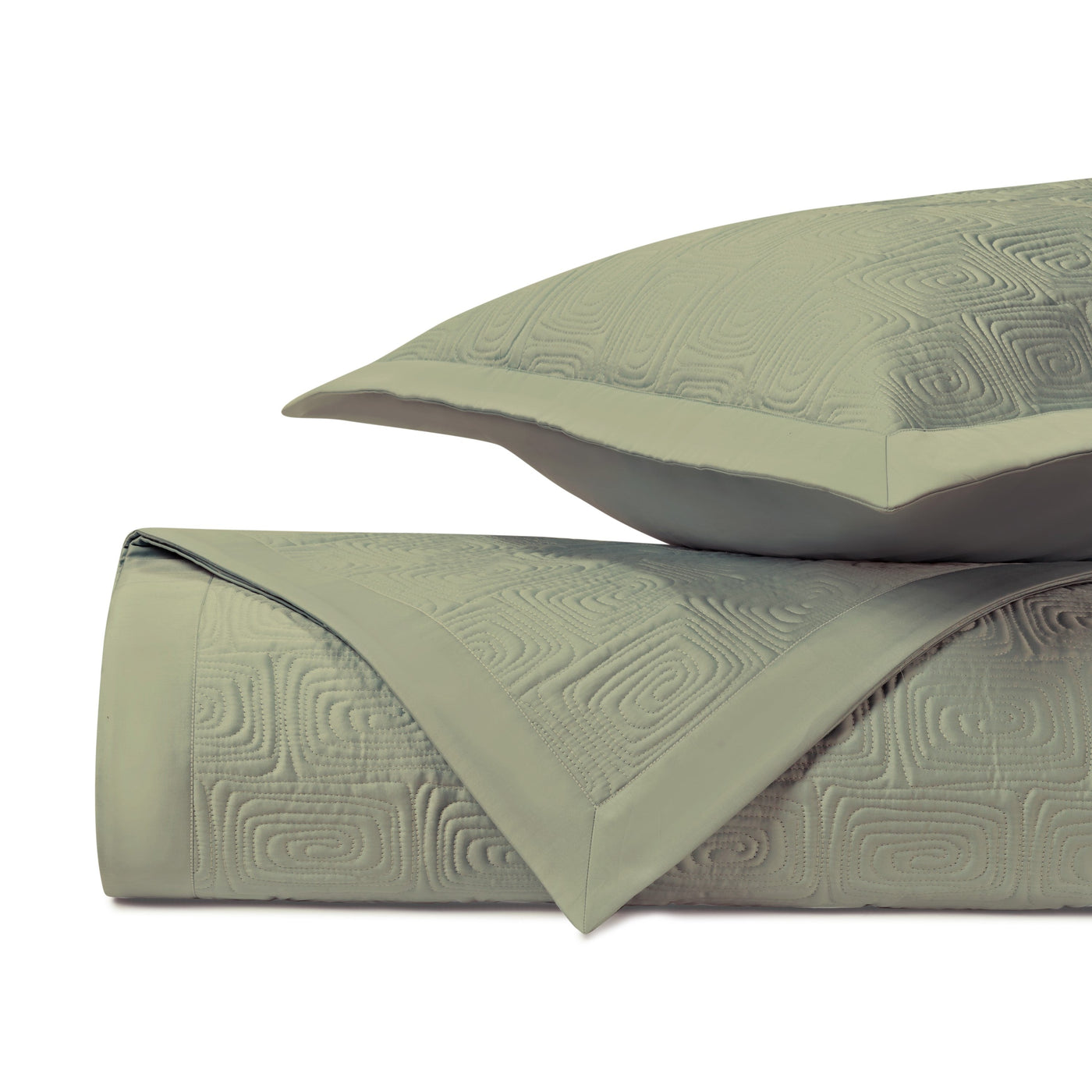 Close-up of Home Treasures Maze quilted coverlet in sage with geometric embossed pattern.