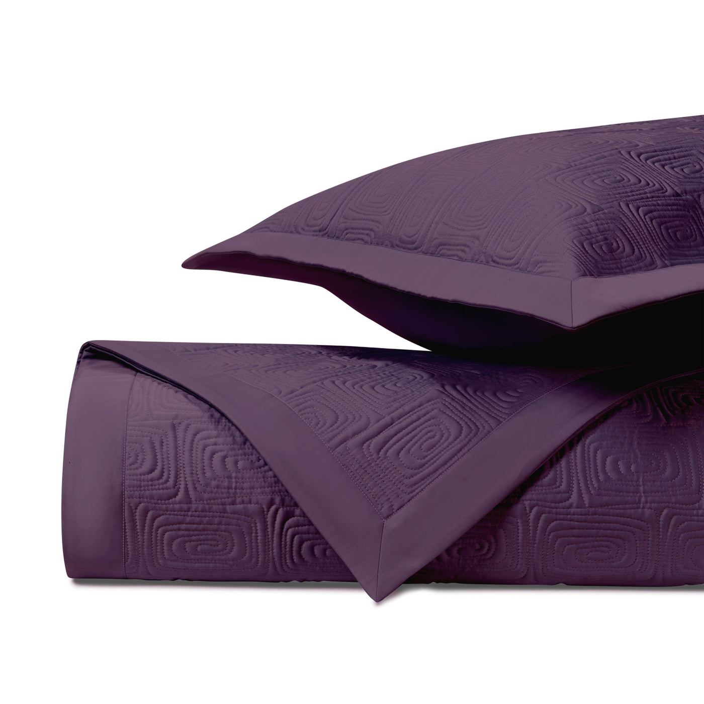 Close-up of Home Treasures Maze quilted coverlet in deep plum with tonal geometric pattern.