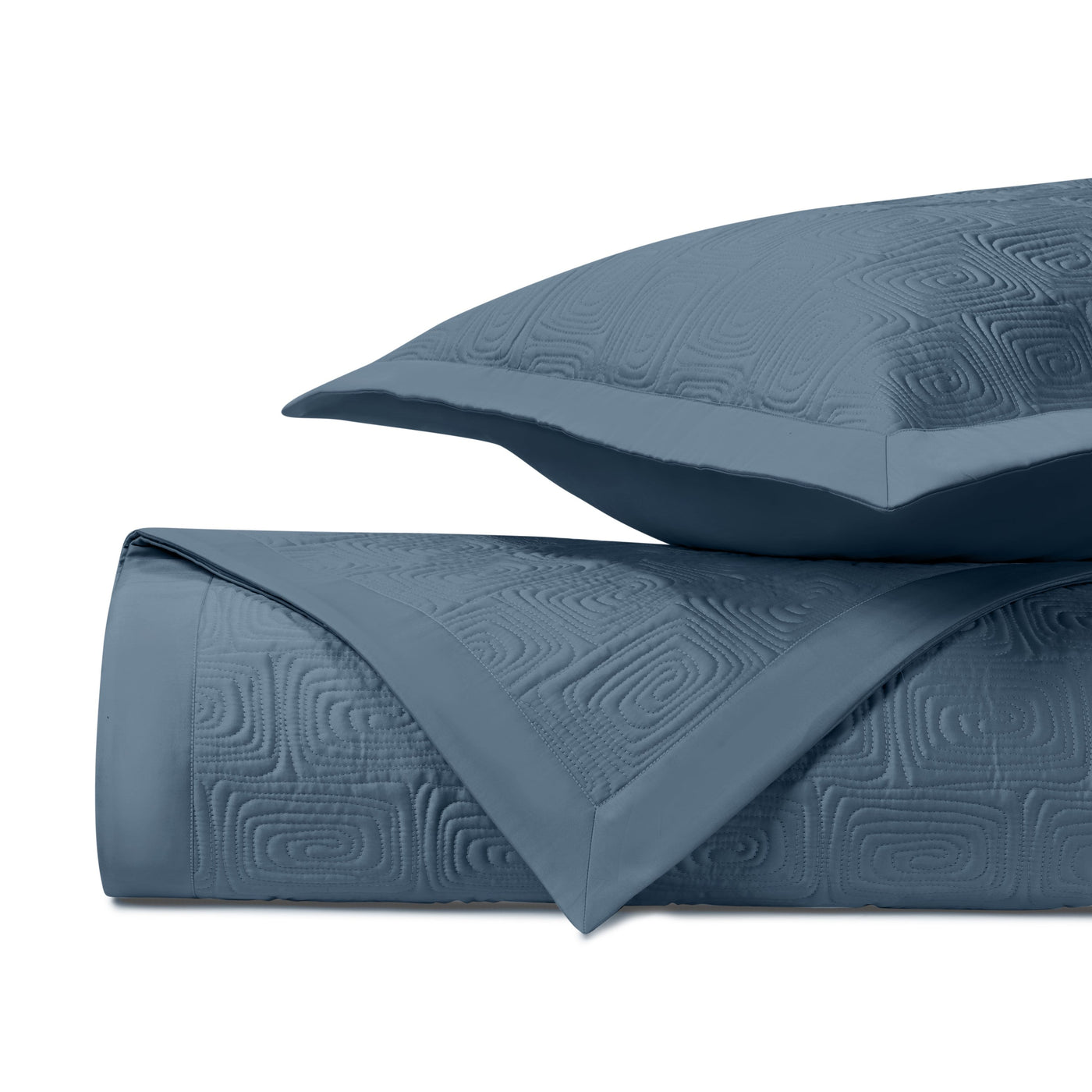Close-up of slate blue quilted Maze pattern with geometric square motif.