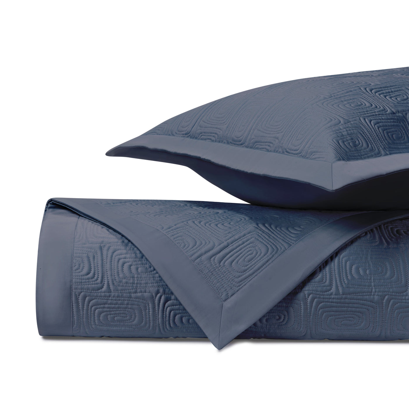 Close-up of Home Treasures Maze quilted coverlet in navy with geometric relief pattern.