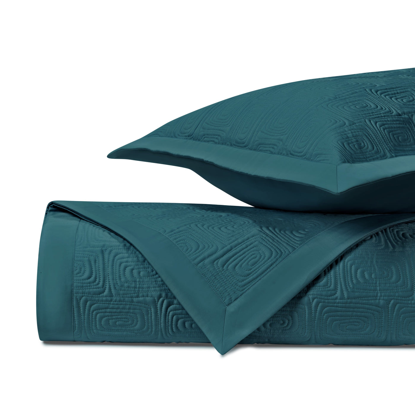 Teal matelassé quilted texture with geometric maze pattern, folded with matching pillow sham.