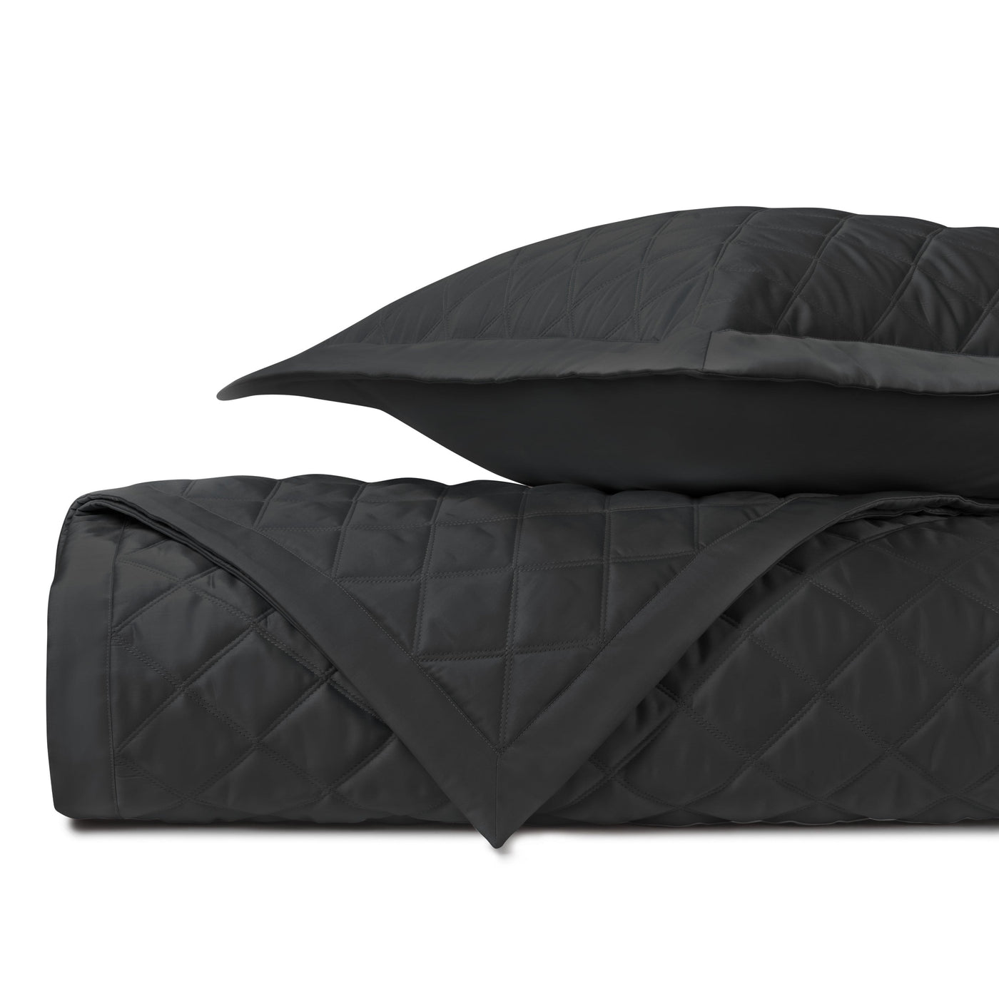 Onyx diamond-quilted satin coverlet and sham, folded to show texture and reverse.