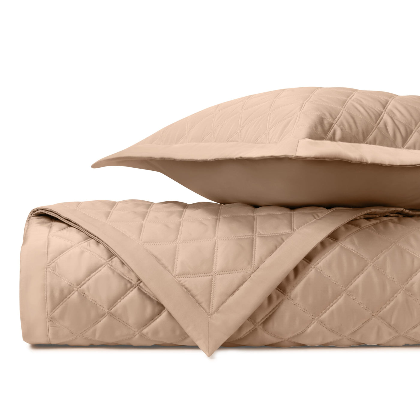 Close-up of Home Treasures Mesa quilted satin in camel, showing diamond stitching detail.