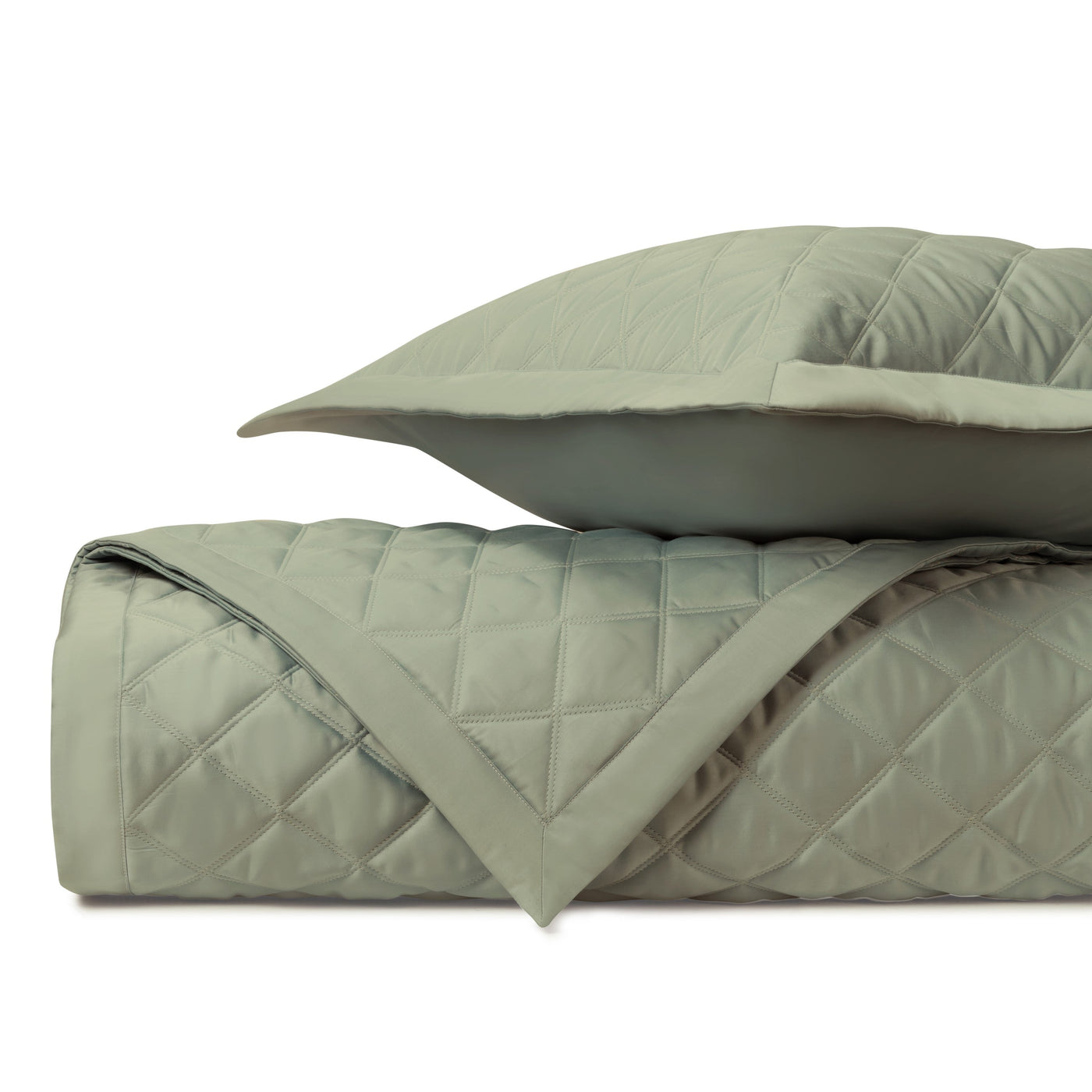 Close-up of Home Treasures Mesa quilted coverlet in sage, showing diamond stitching detail.