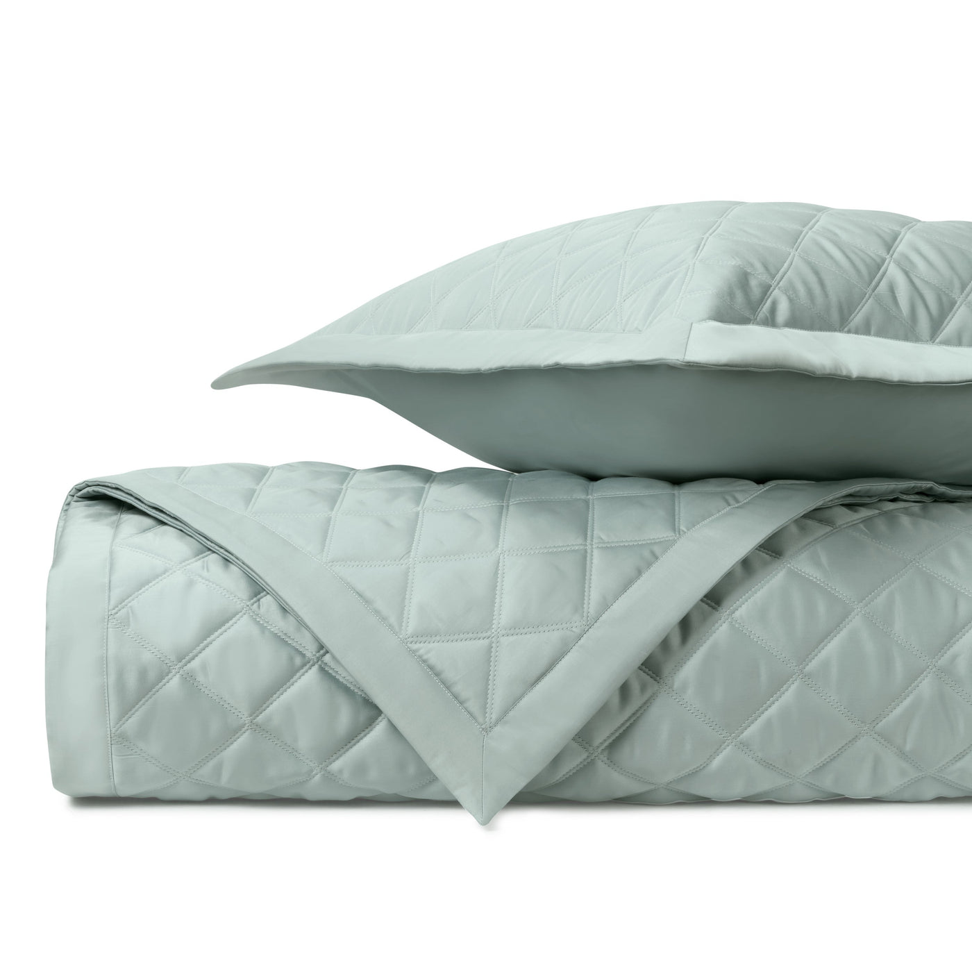 Close-up of Mesa quilted coverlet in seafoam with diamond stitching pattern and sham.