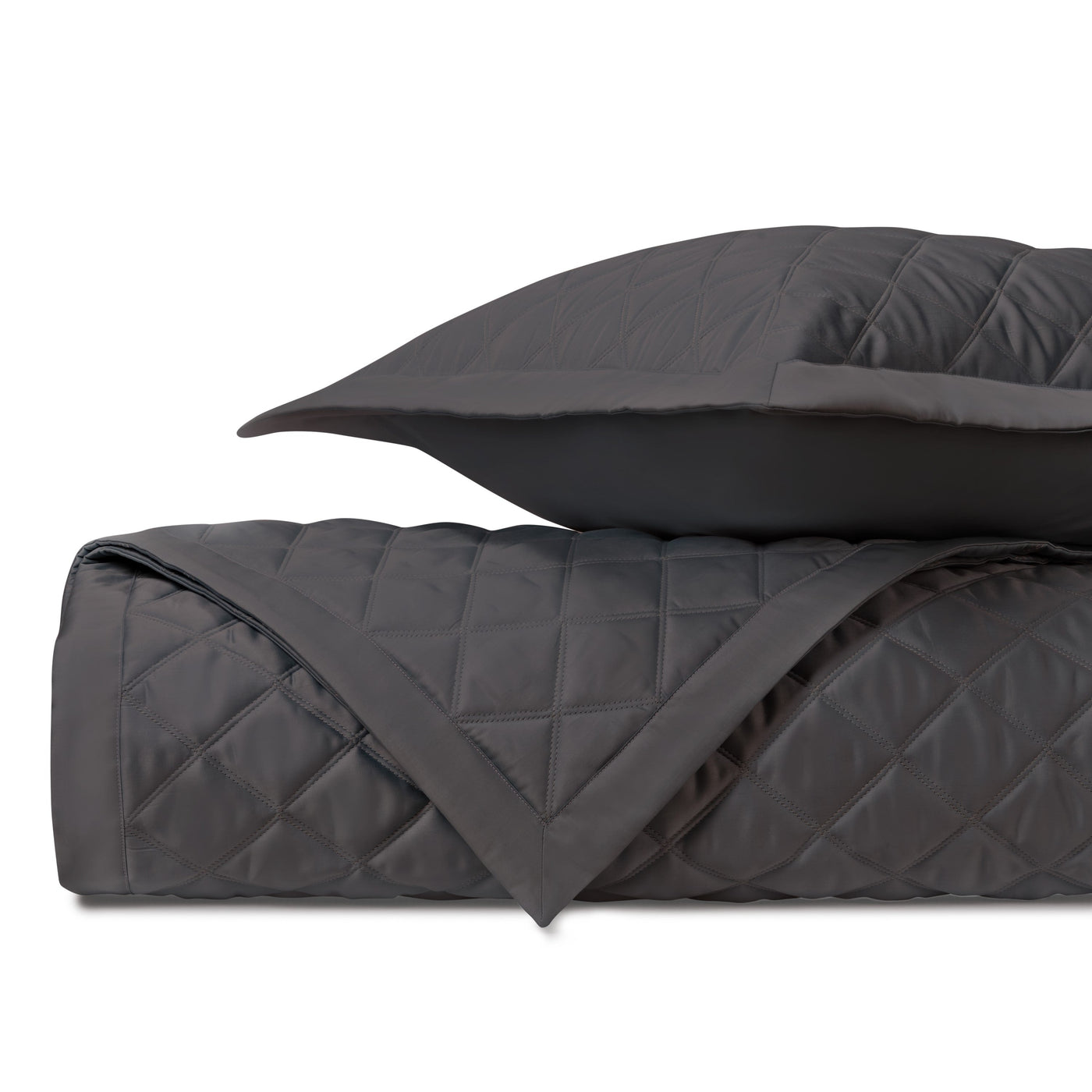 Close-up of charcoal quilted diamond-pattern coverlet with coordinating sham.