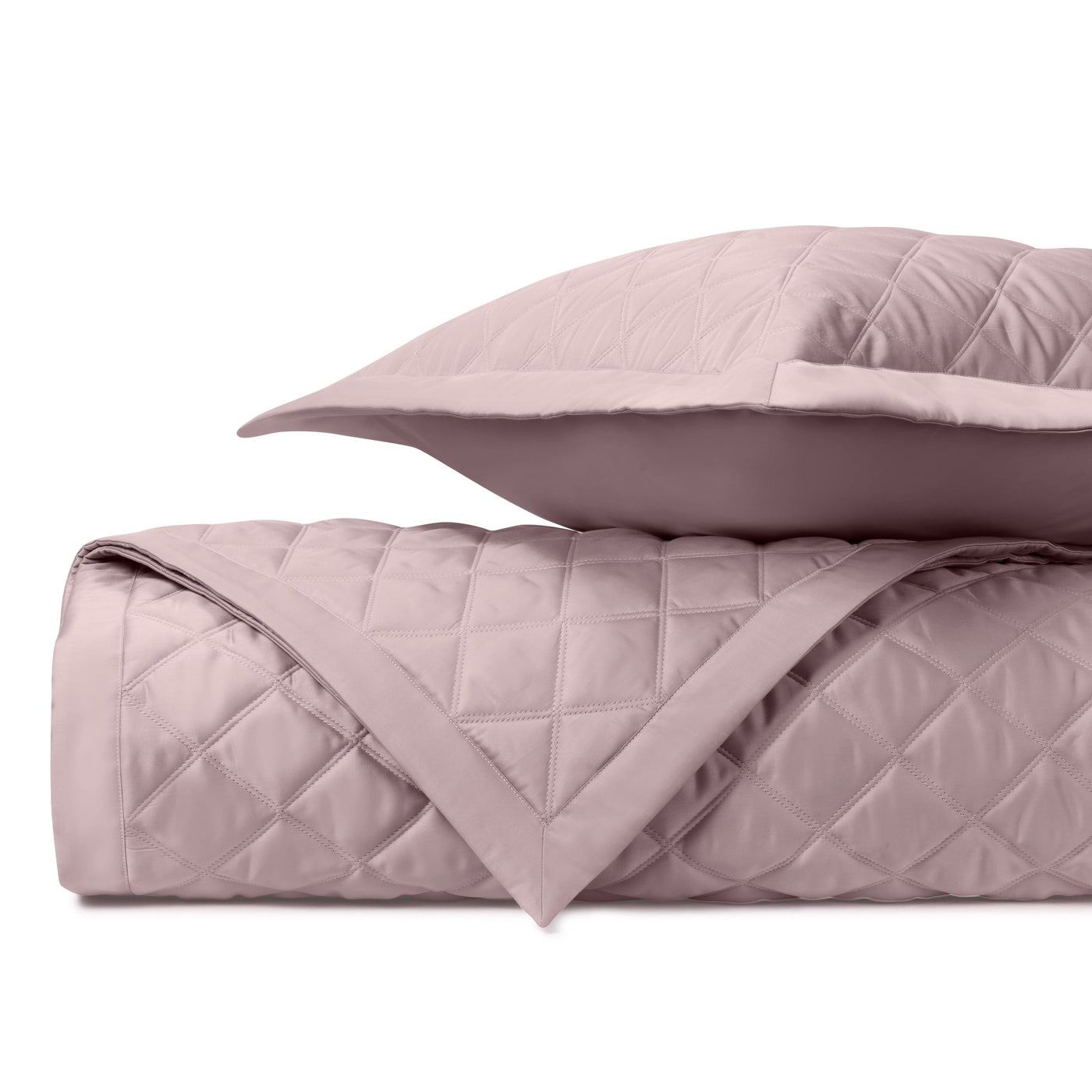 Close-up of Mesa quilted satin in blush, showing diamond stitching and sham edge detail.